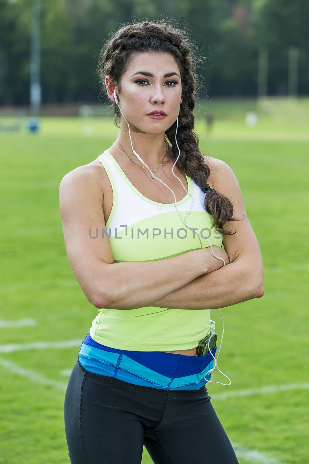 An athletic female exercising on a track outdoors