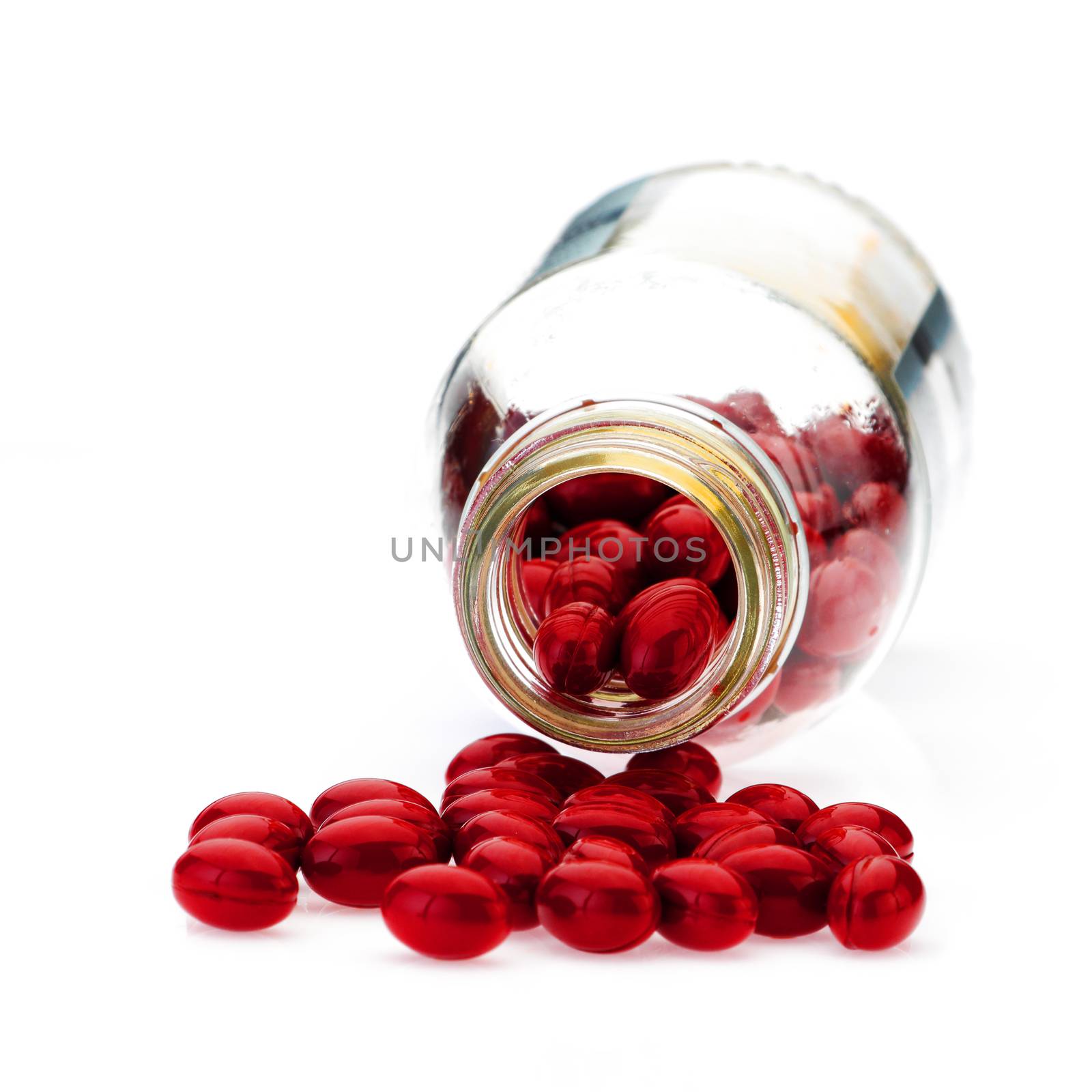 A pile of capsual pills and medication bottle