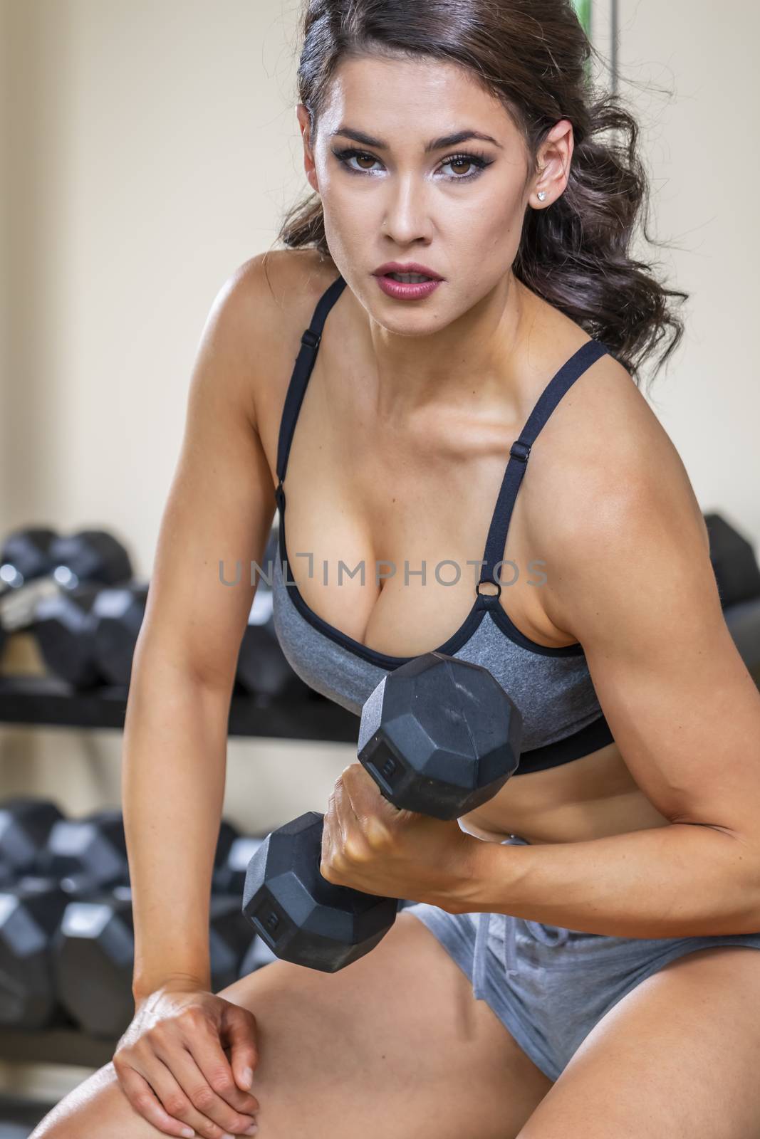 A brunette fitness model preparing to work out