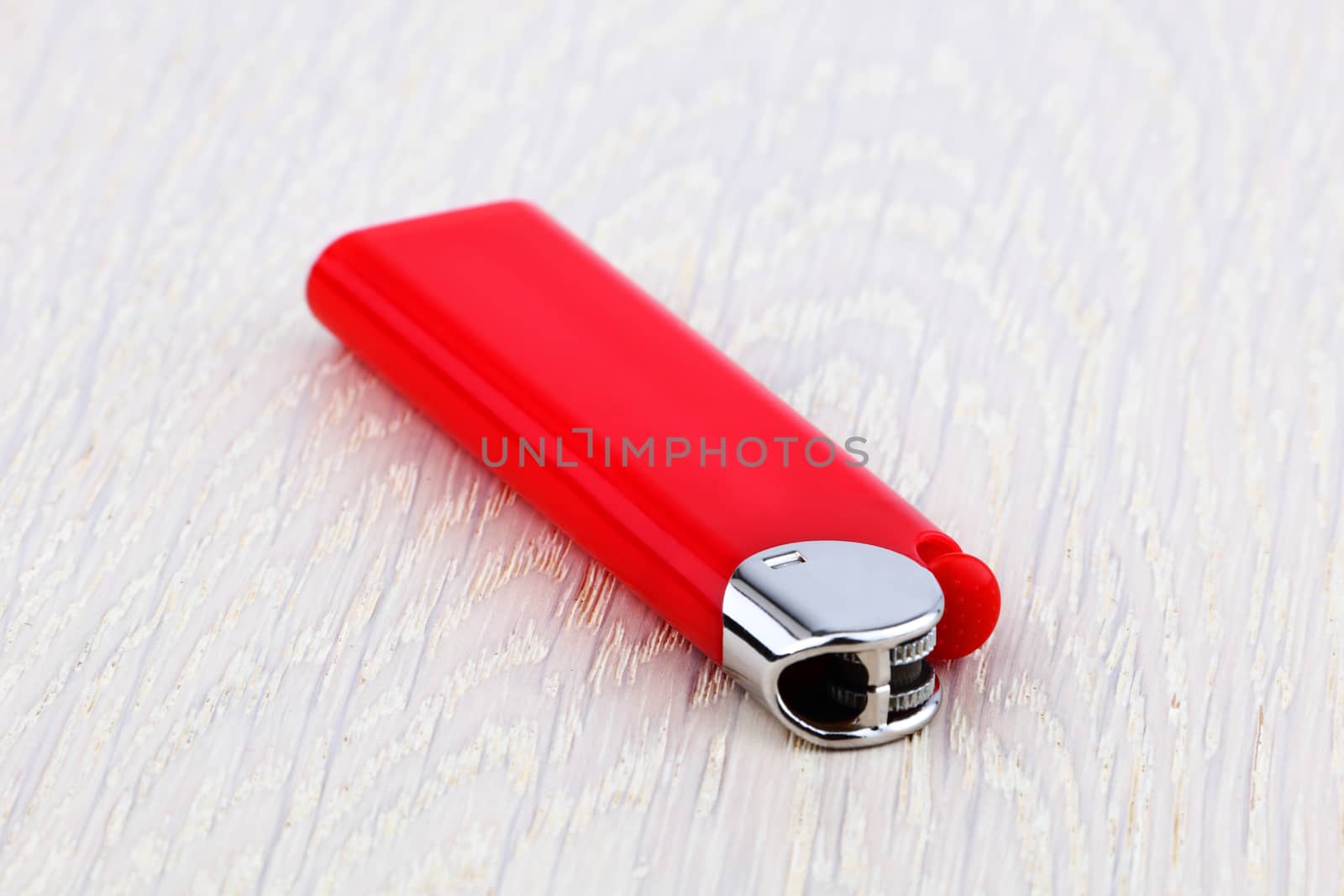 Red lighter on wood background