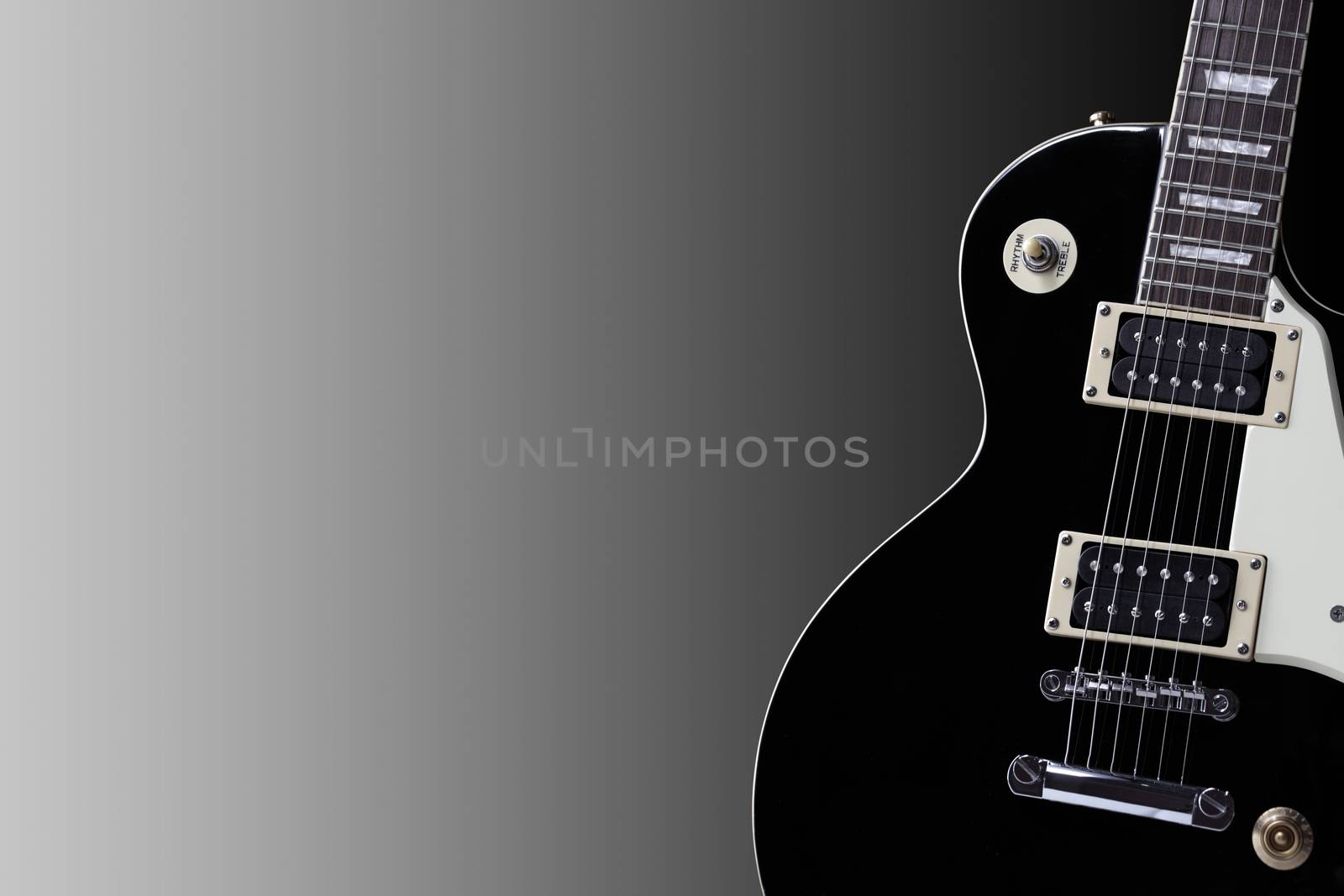 Section of an old black electric guitar body with copy space by VivacityImages