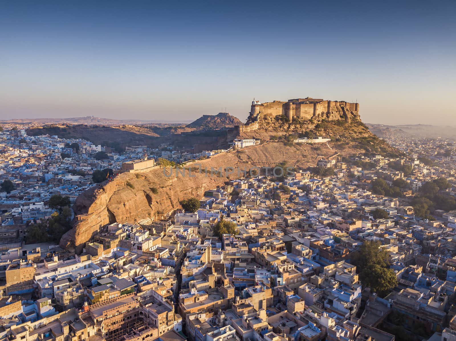 Aerial view of Mehrangarh Fort at sunset sits above the 'Blue City' Jodhpur, Rajasthan State India.