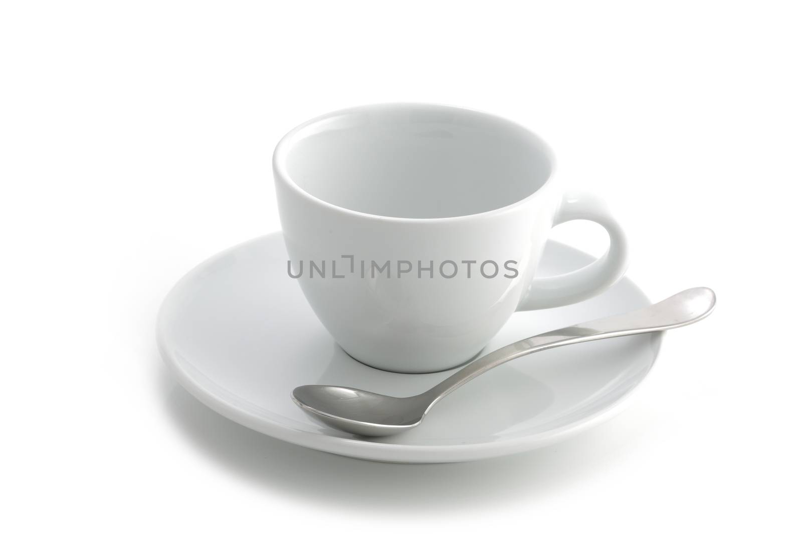 An empty white coffee cup and saucer and spoon isolated on a white background