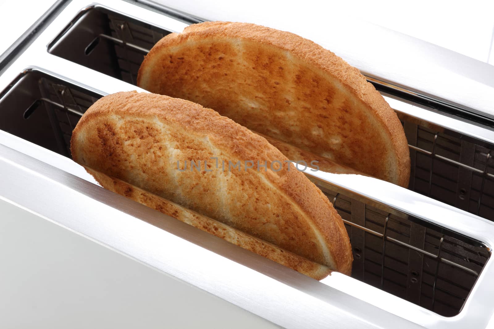 Toast in a toaster two slices golden brown from above