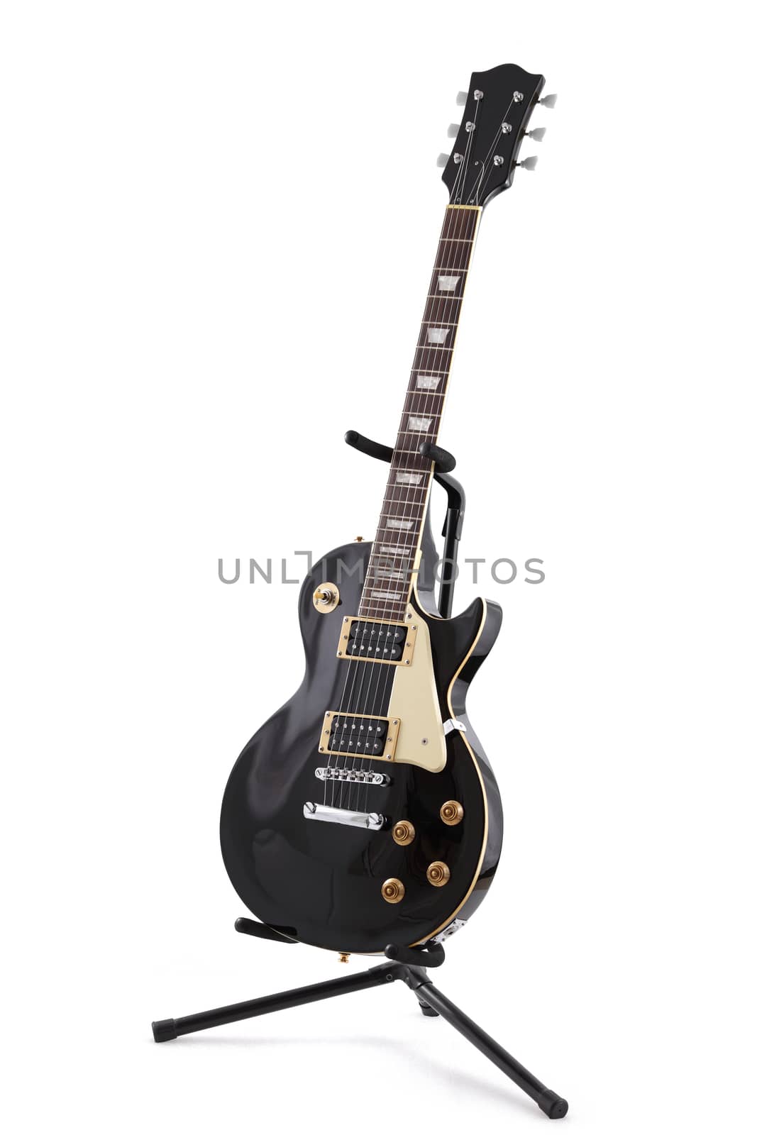 A black electric guitar on a stand isolated on white with clipping path