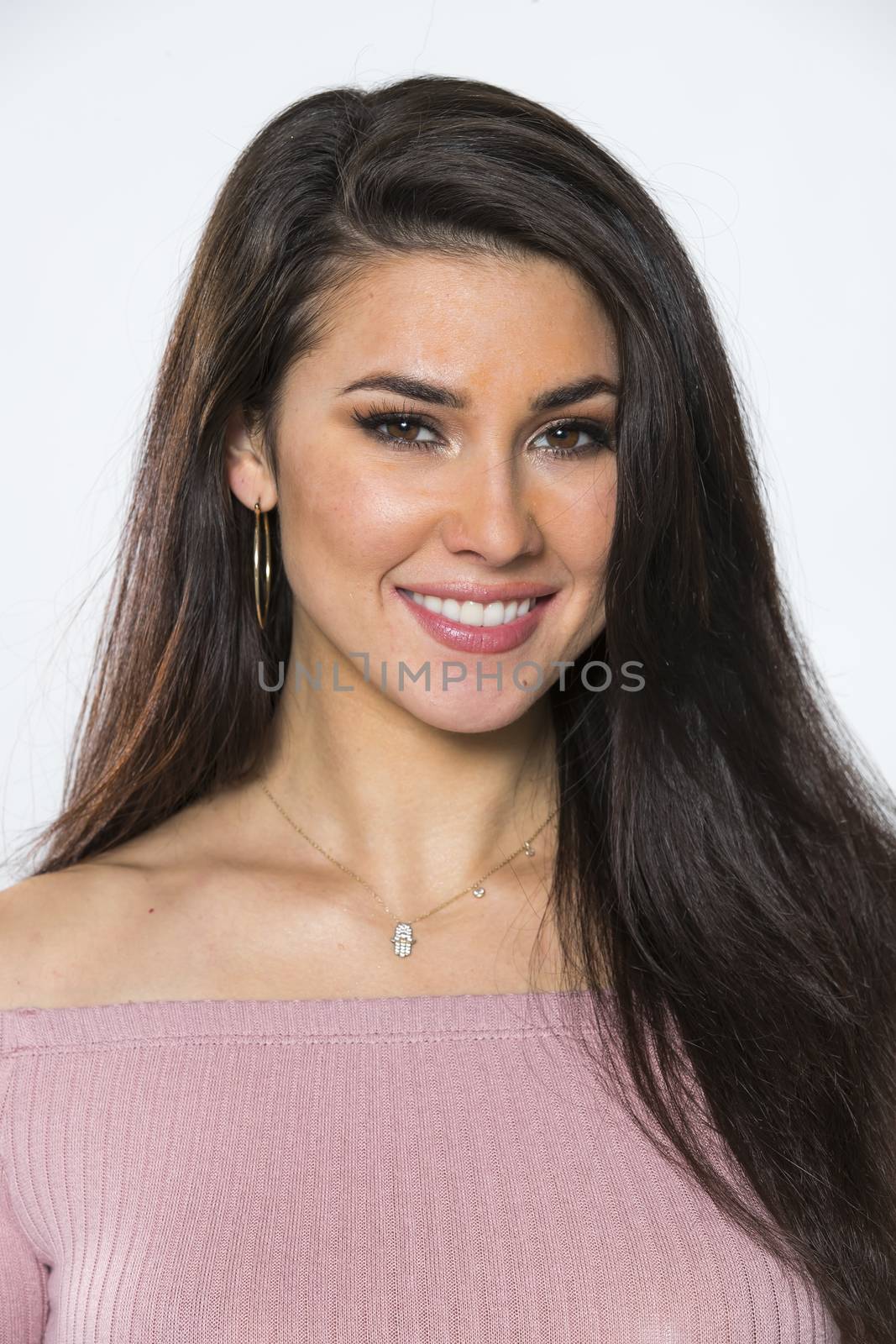 A gorgeous brunette model posing in a studio environment