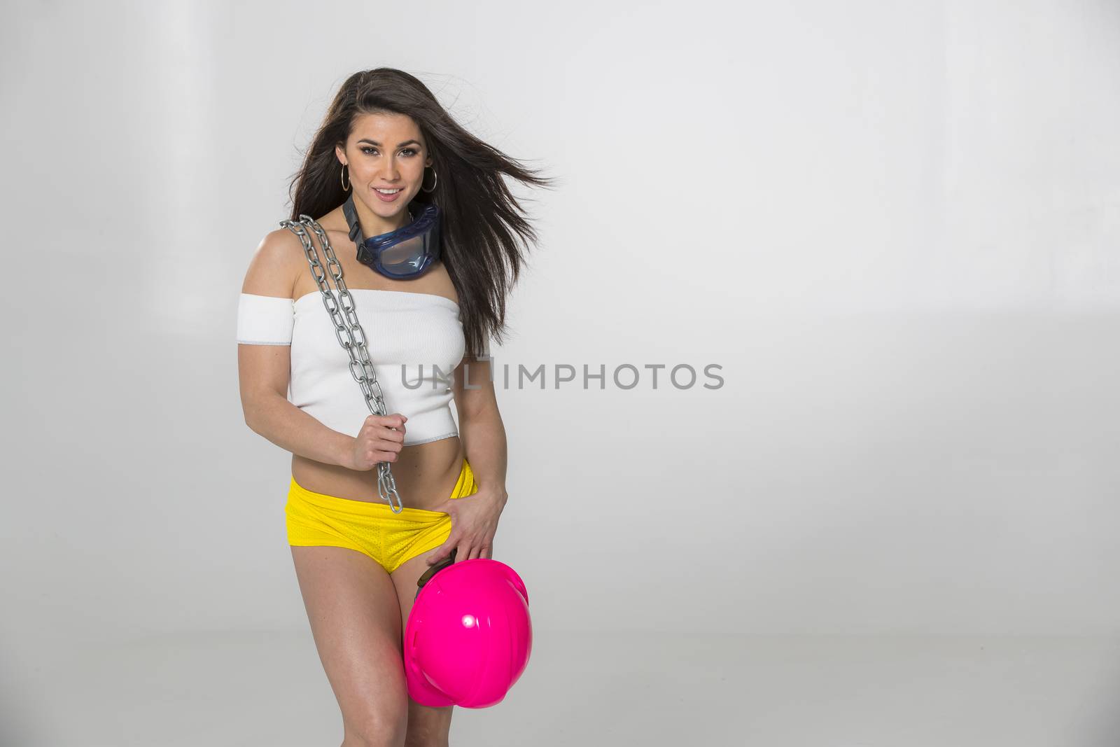 A gorgeous brunette model posing in a studio environment