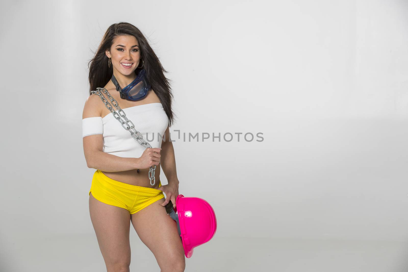 A gorgeous brunette model posing in a studio environment