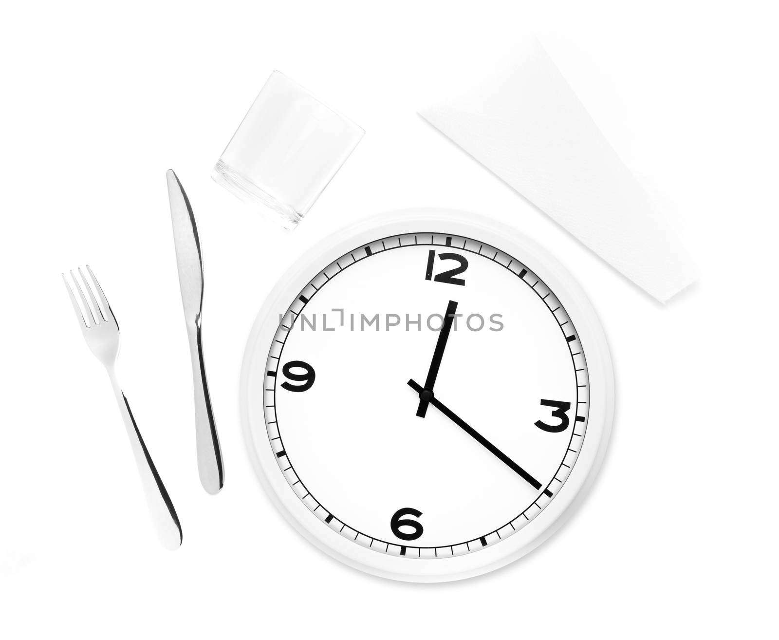 Fork, knife, glass, napkin and white round clock isolated in white background. Time to eat concept.