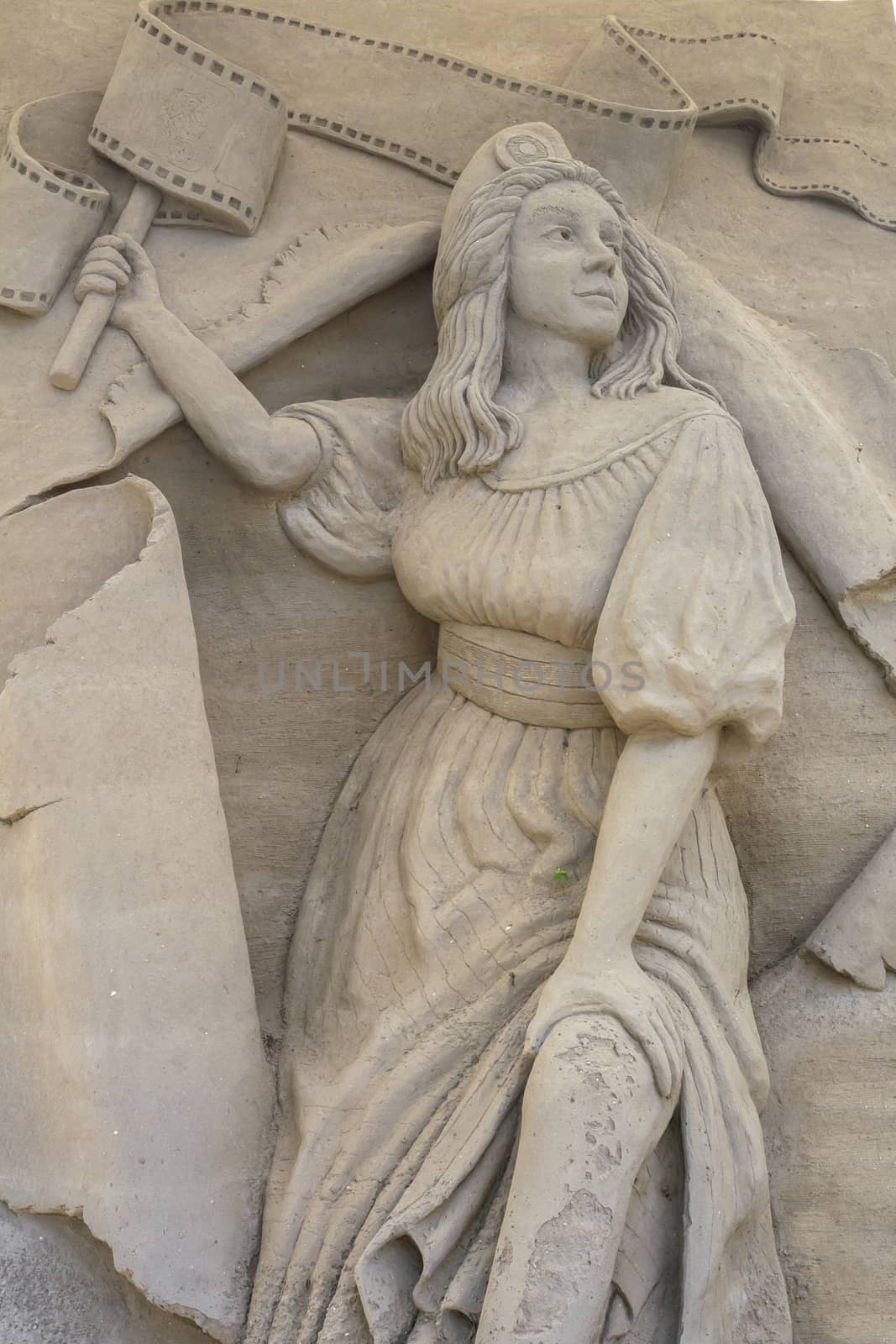 Sand sculpture of a woman. It can be used as background.