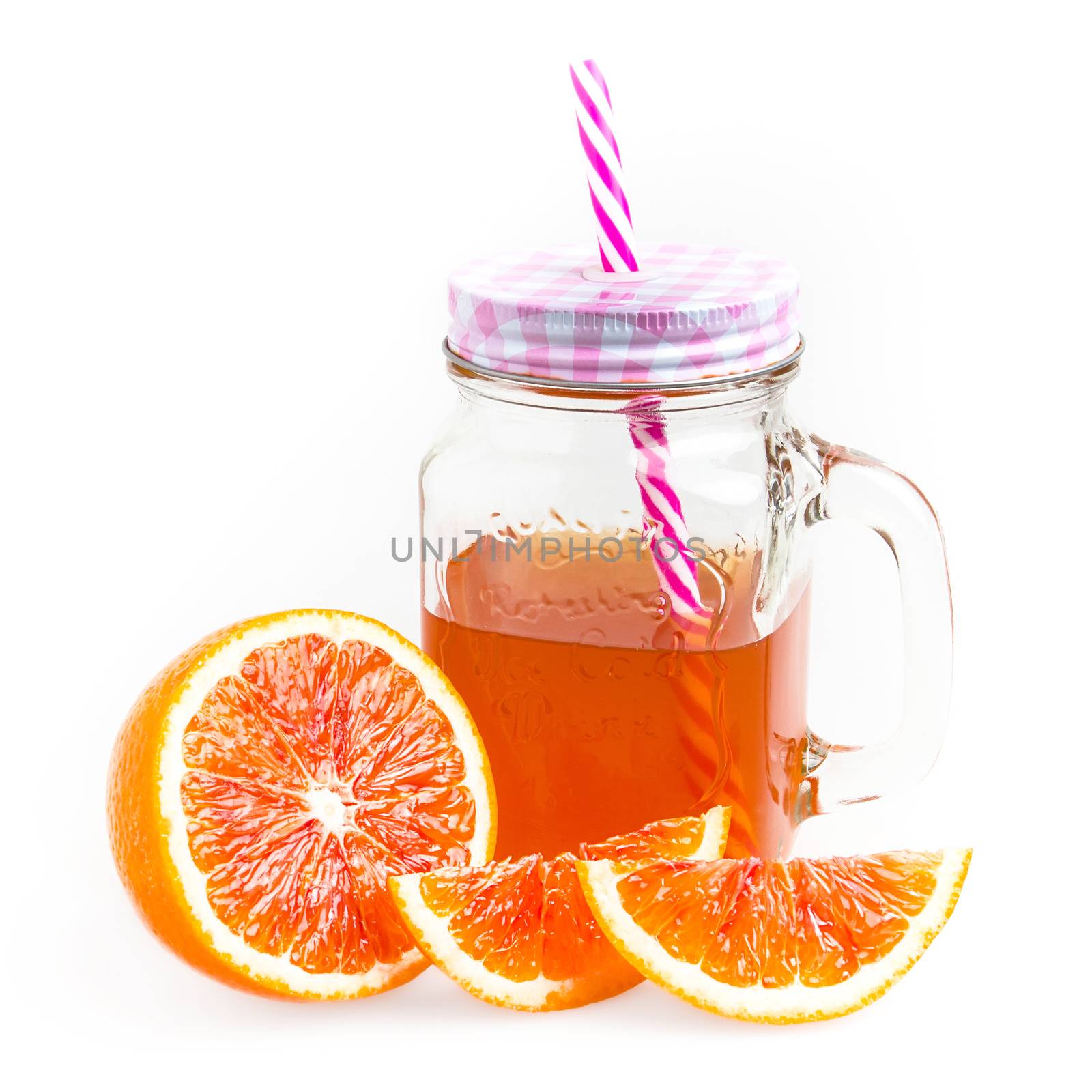 Mason jar glass of tea with oranges isolated on a white background