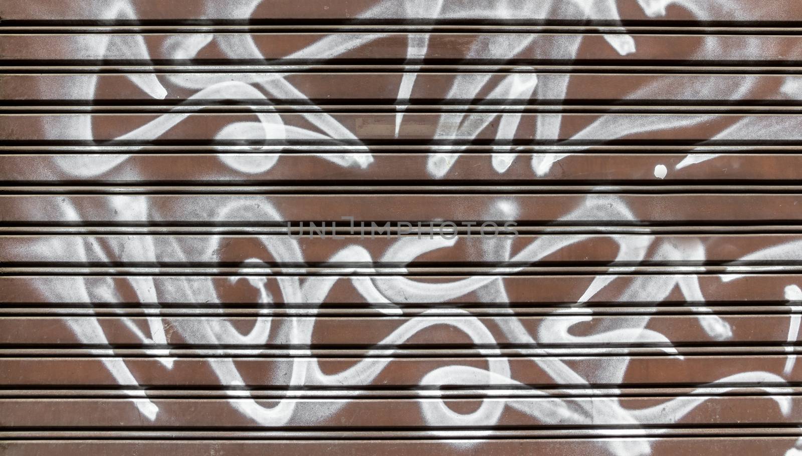 Garage gate with graffiti by germanopoli