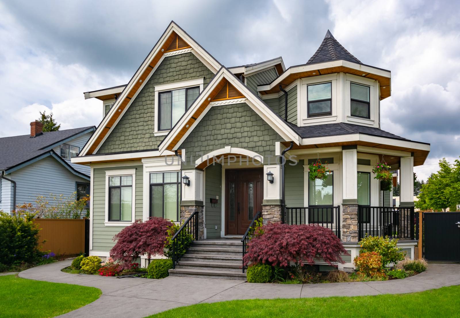 Luxury residential family house with concrete pathway over green lawn. Family house with car parked on side