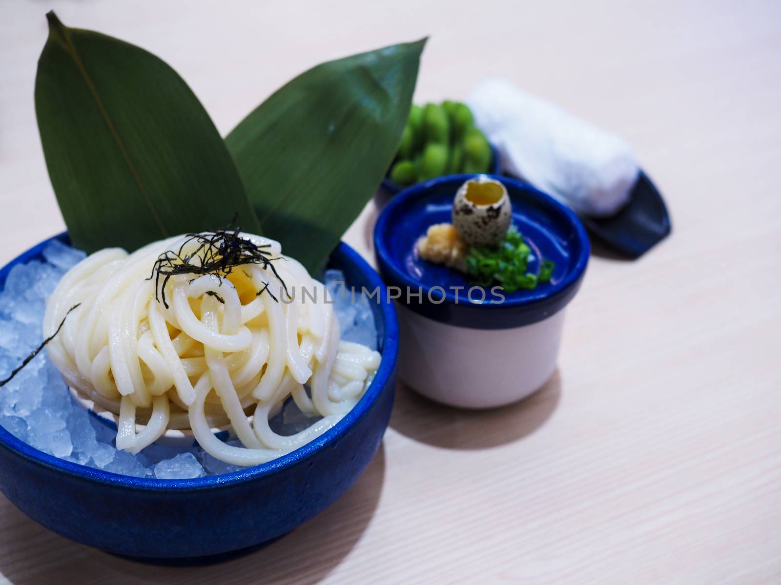 Zaru Soba, Udon noodles or Ramen. japanese food in the blue bowl with ice below.