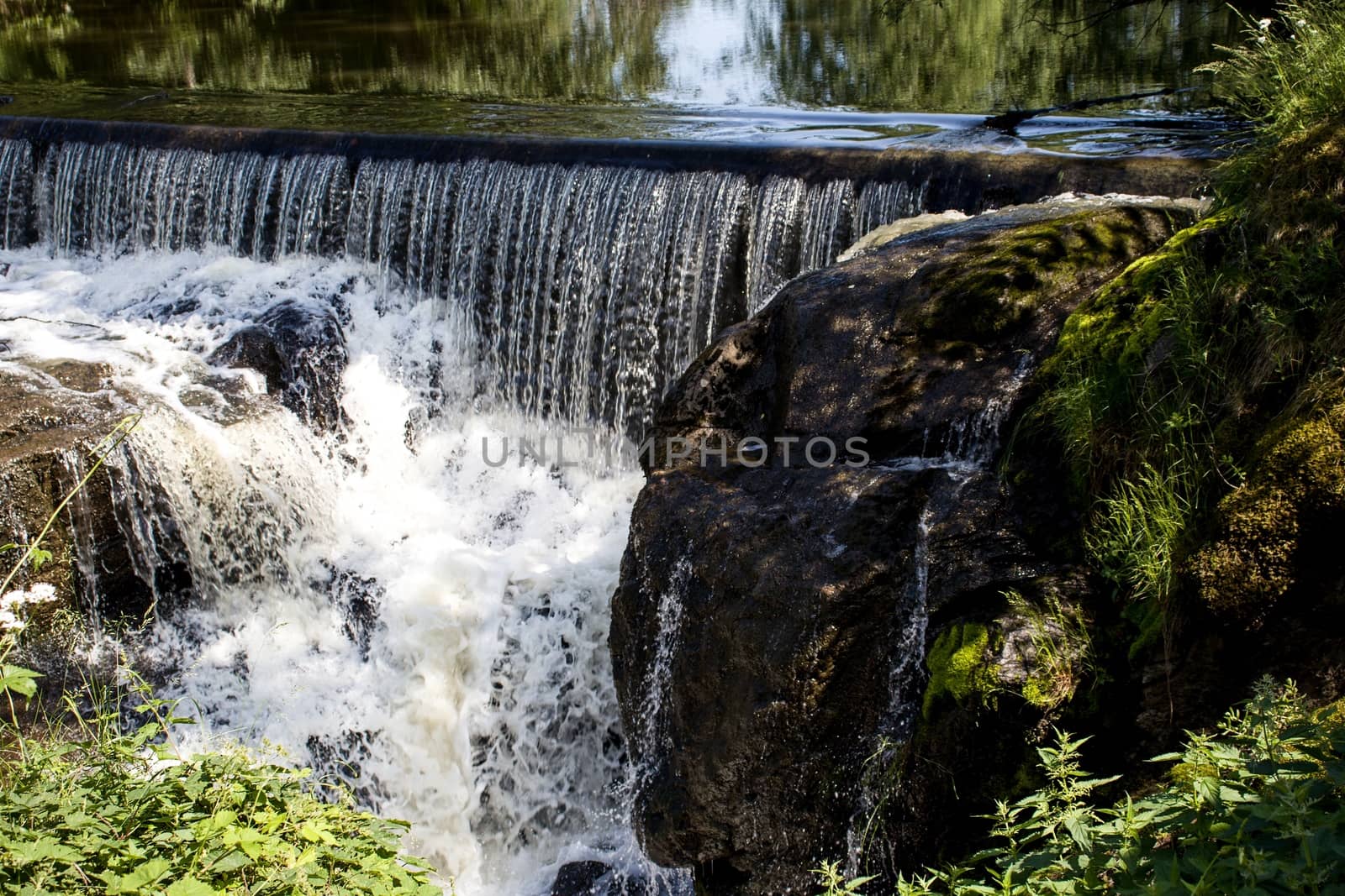 A small waterfall off an old powerplant dam, in the forest