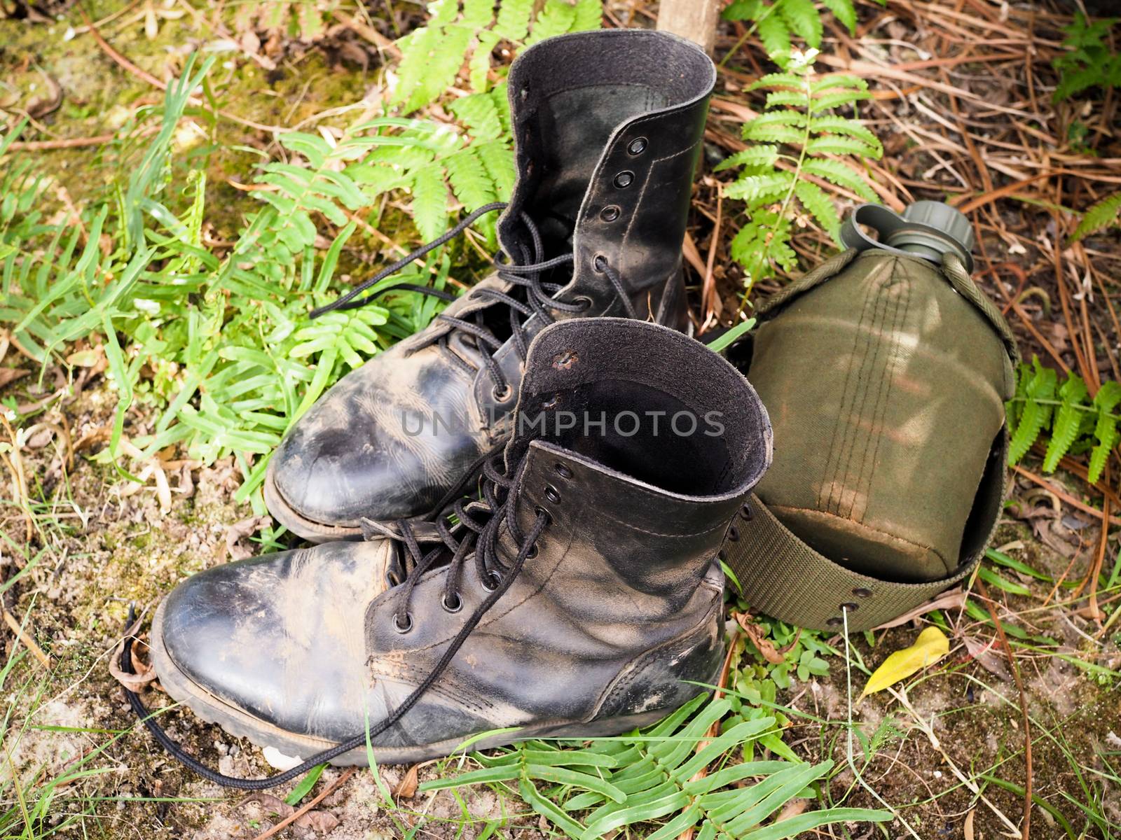 Military boots or men combat shoes and water bottles Or equipment for hiking