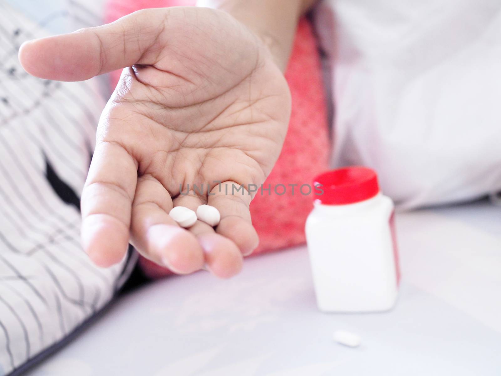 People with stomach pain, holding drugs or painkiller on hand by kittima05
