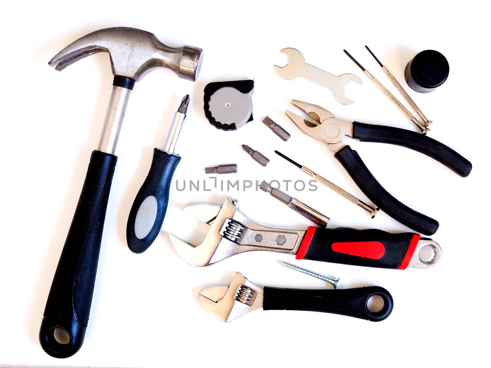 Tool kit For construction work with Old hammer, wrench, pliers, screwdriver, nut, Measuring Tape isolated on white background