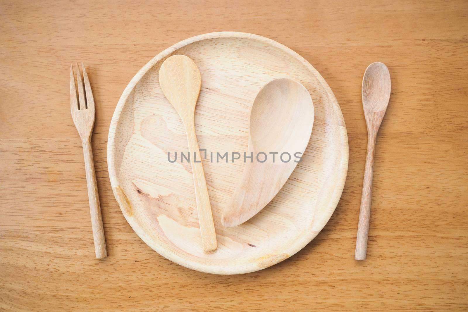 wooden table with Plate and spoon wooden. by kittima05