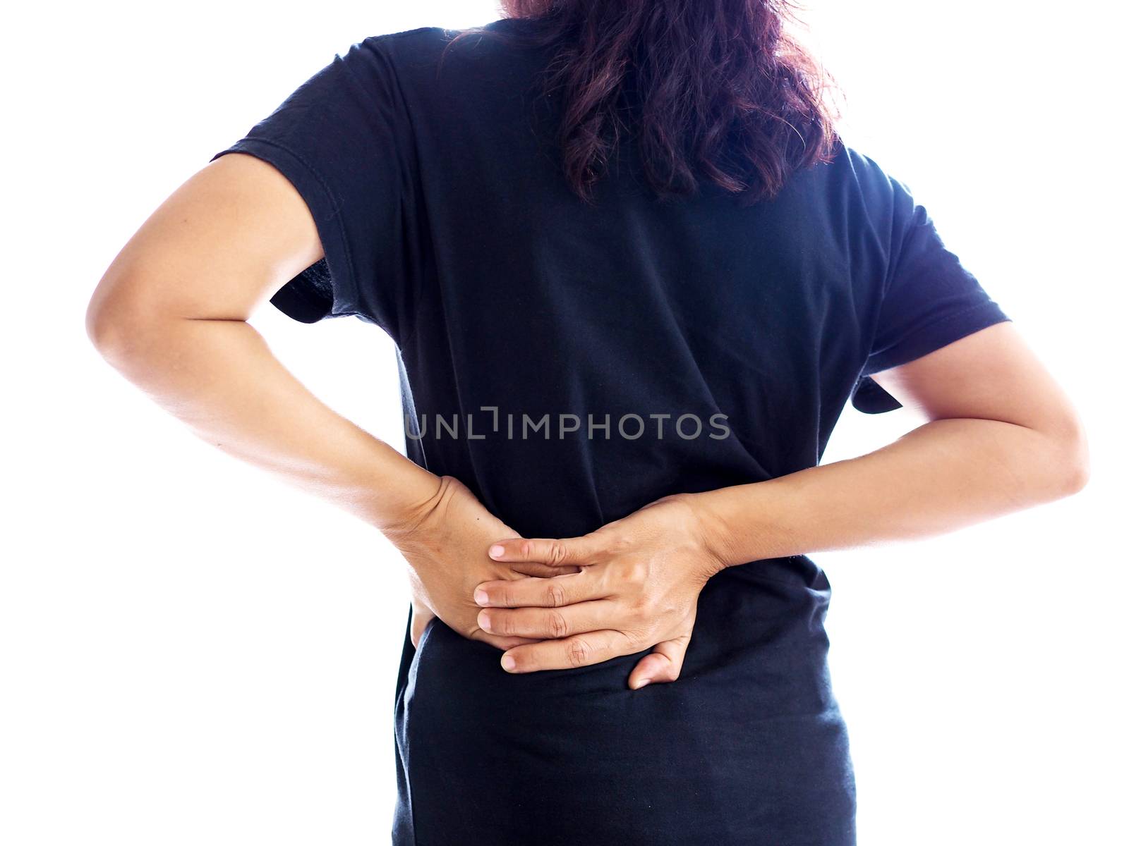 Asian woman with back and waist pain use hand massage to relax and relieve symptoms.