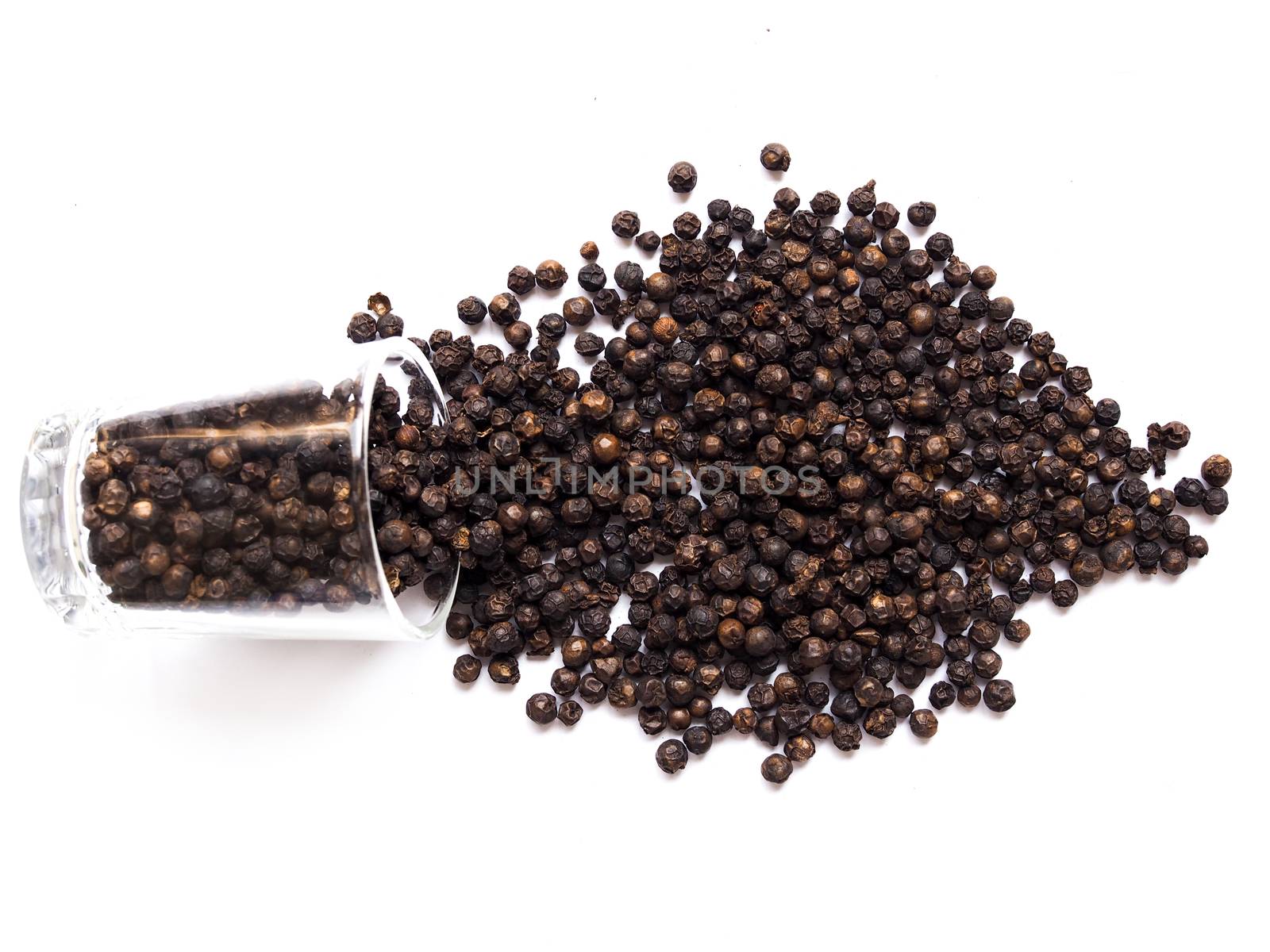 Dried black pepper seeds, peppercorn in a clear glass by kittima05