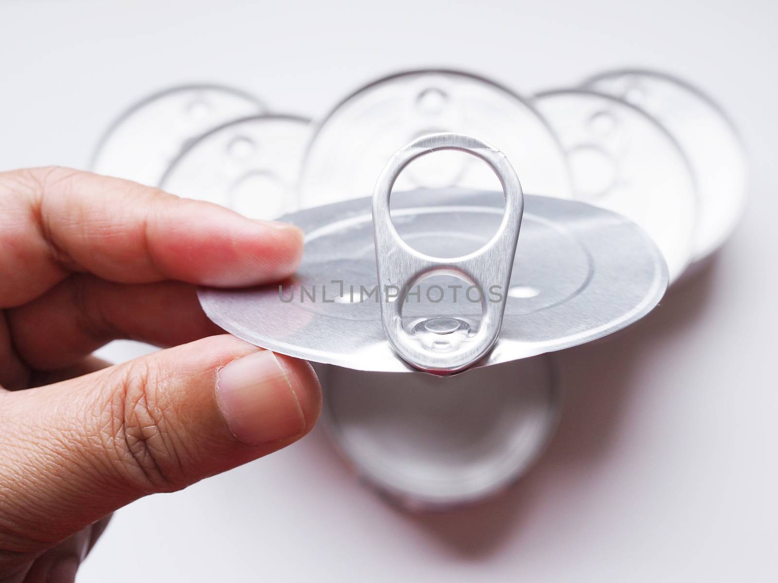 Hand holding lid of Can metal with recyclable food containers.