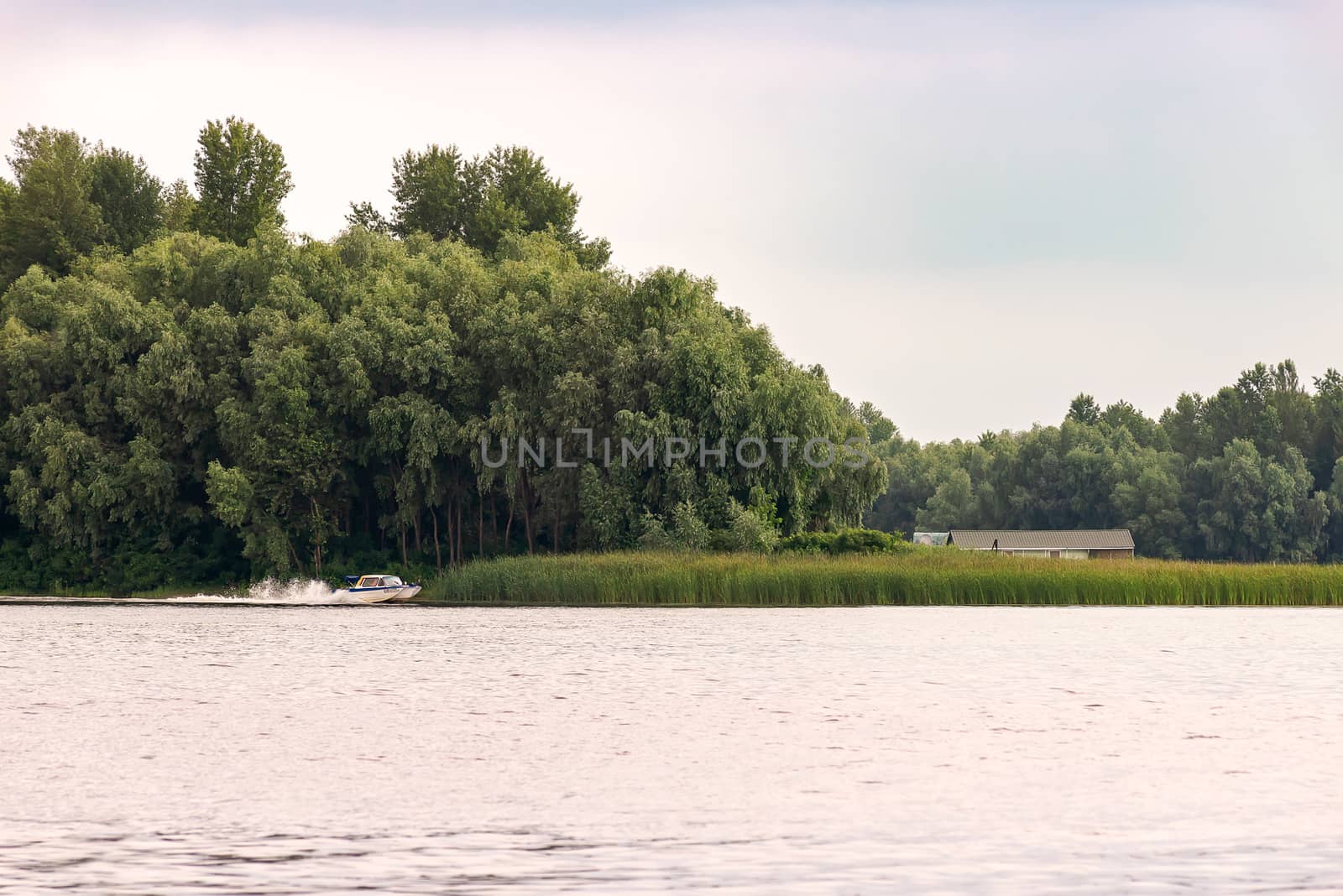 A speedboat on the Dnieper river in Kiev, Ukraine, at the beginn by MaxalTamor