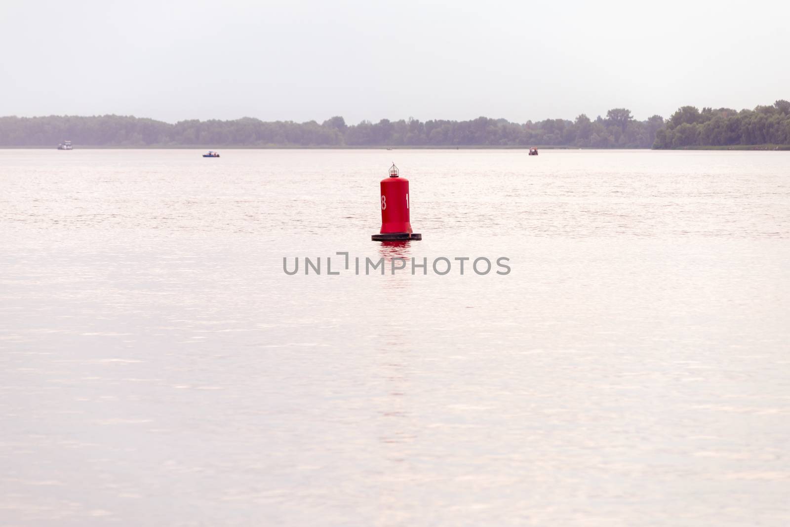 A red buoy on the Dnieper river in Kiev, Ukraine, for the safety and security of the boats travelling on the water. Selective focus