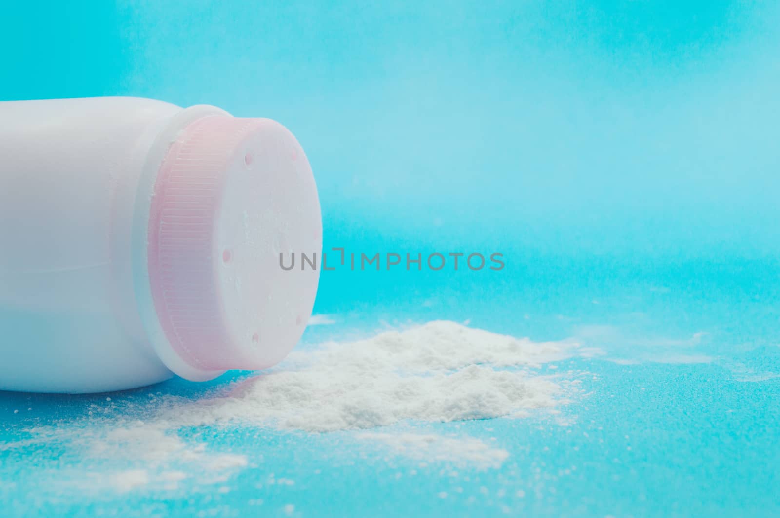 Baby talcum powder container on blue background