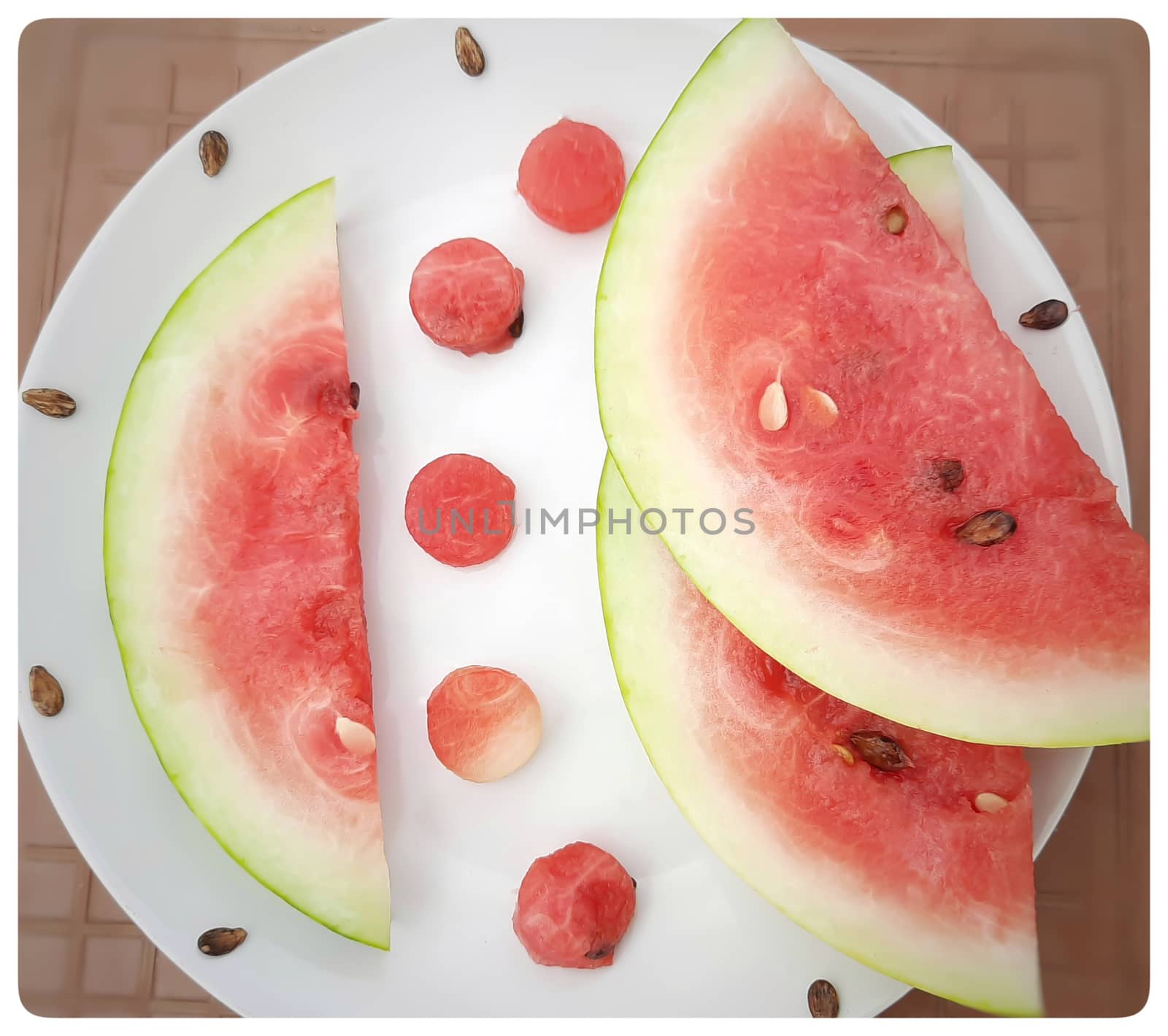 Chill pink color slices of watermelon with round shape cut pieces in white plate and good drink for summer days and healthy fruit and also to keep body hydrate drink