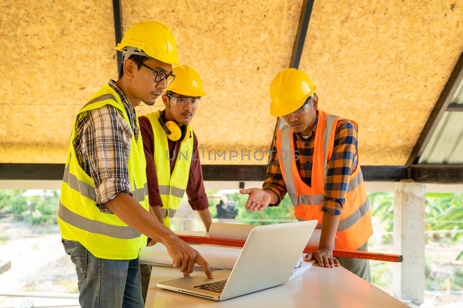 Engineer and architect meeting or discussing work in office or construction site.