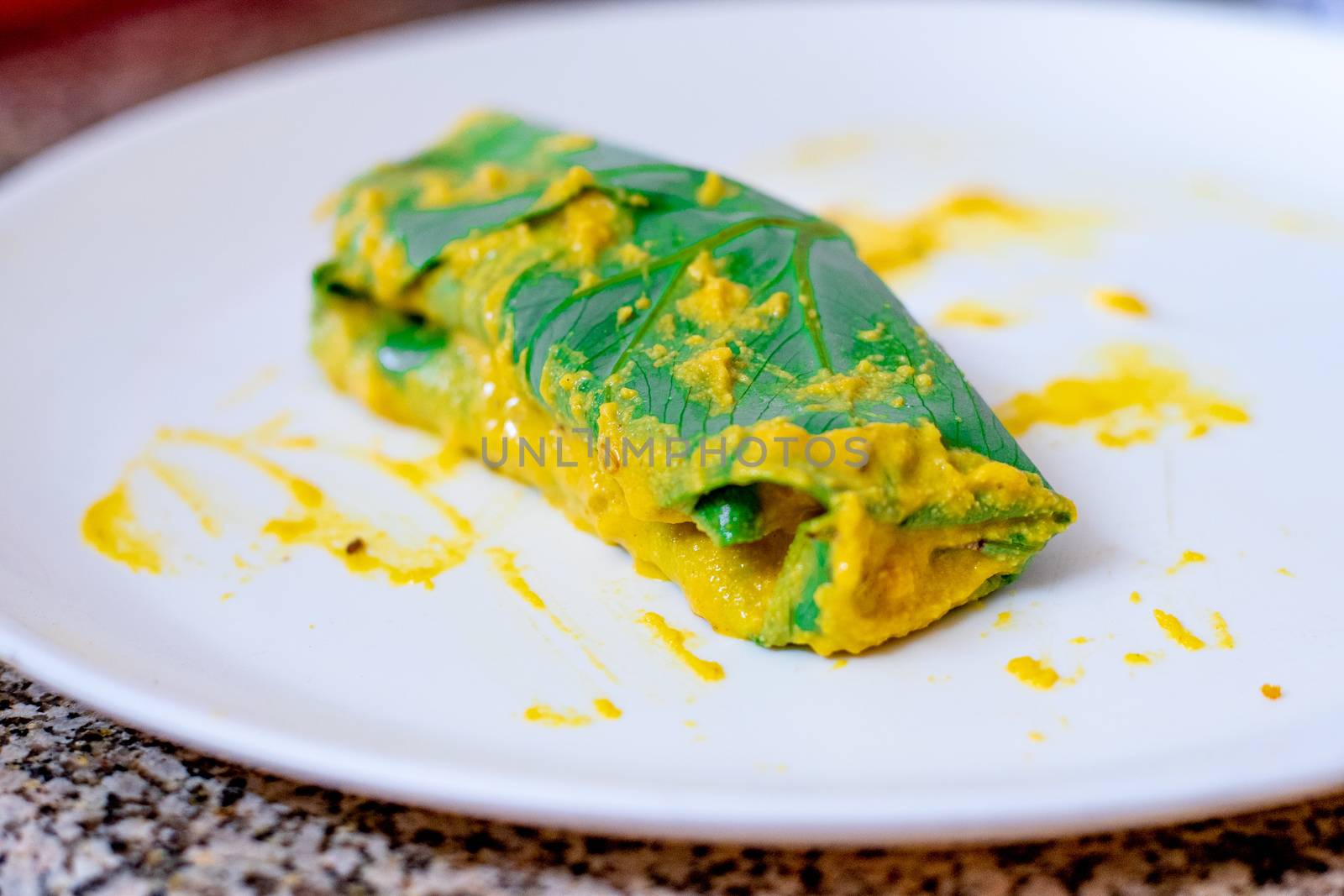 Beautiful Arvi colocasia root leaves coated with flour gram and turmeric paste and wrapped and tied ready for frying. This is a popular dish in North india especially in cities like Mumbai, Delhi and other to make pakode bhajiya and more