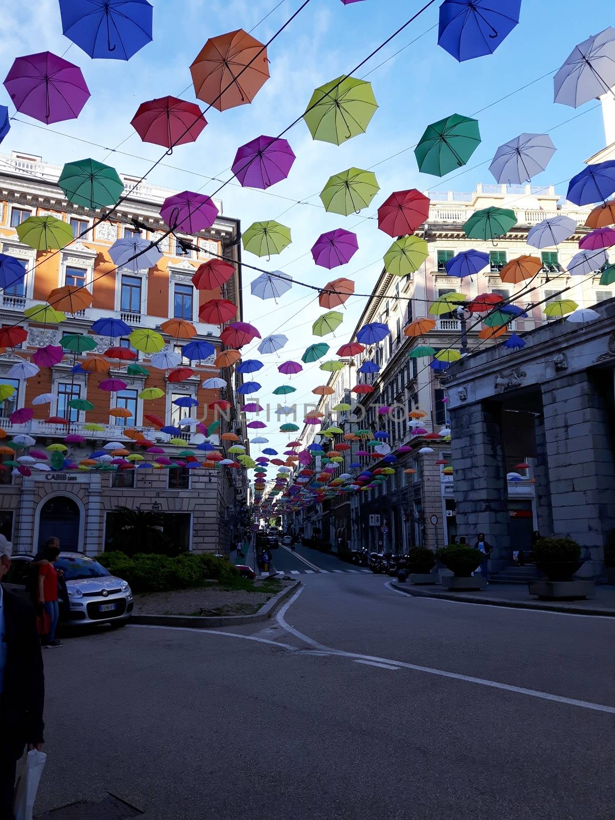 Genova, Italy - 06/01/2020: Bright abstract background of jumble of rainbow colored umbrellas over the city celebrating gay pride