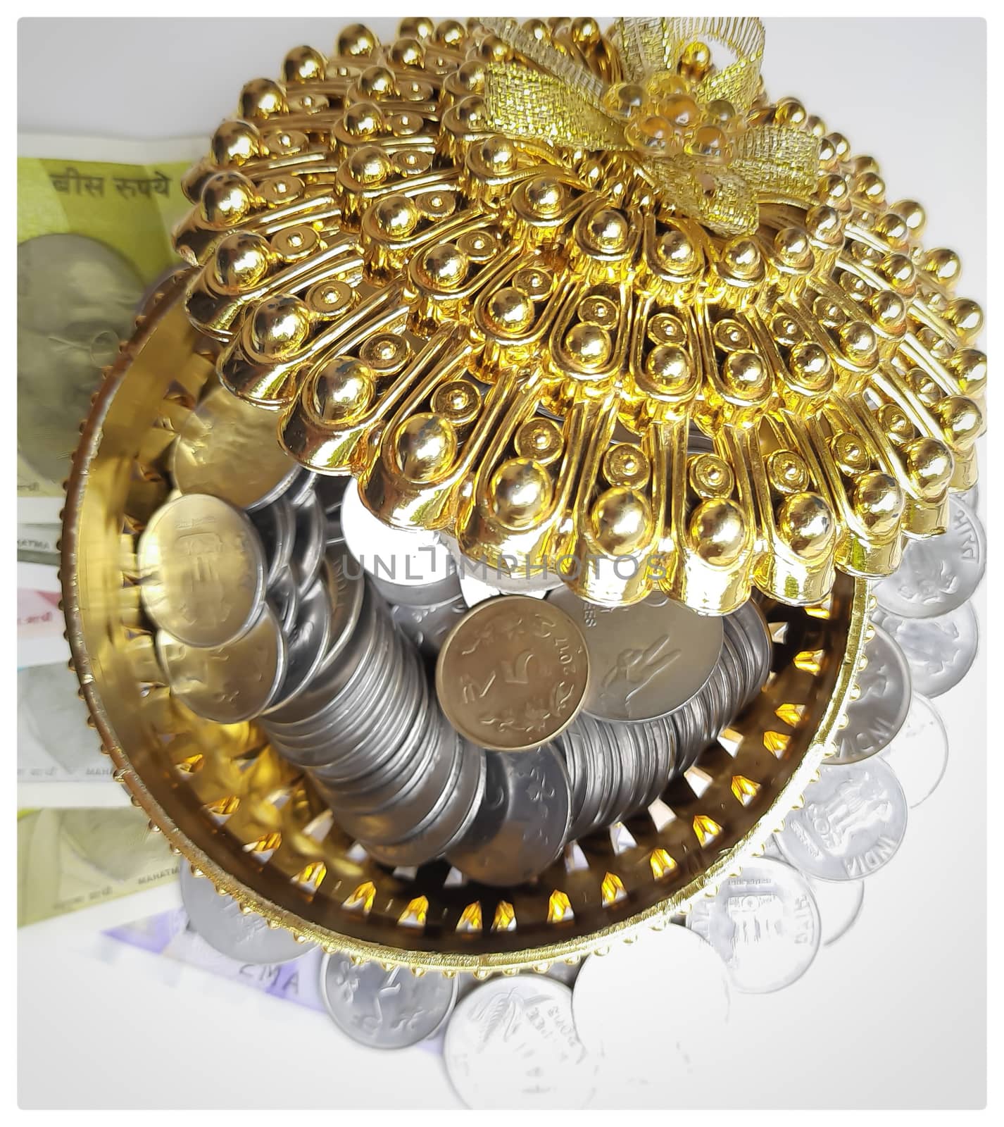 Indian new currency spread randomly with coins in golden color gift box beautifully and 500 rupees with rubber band
