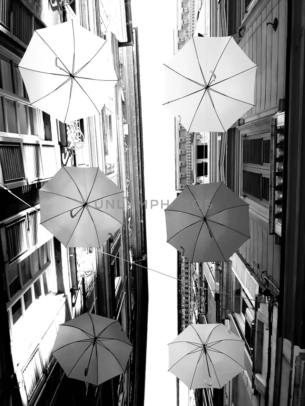 Genova, Italy - 06/01/2020: Bright abstract background of jumble of rainbow colored umbrellas over the city celebrating gay pride