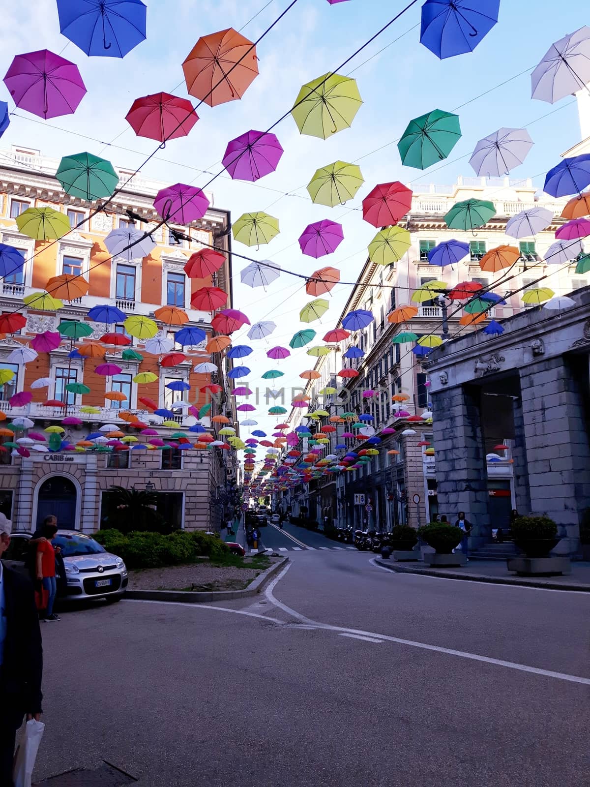 Genova, Italy - 06/01/2020: Bright abstract background of jumble of rainbow colored umbrellas over the city celebrating gay pride