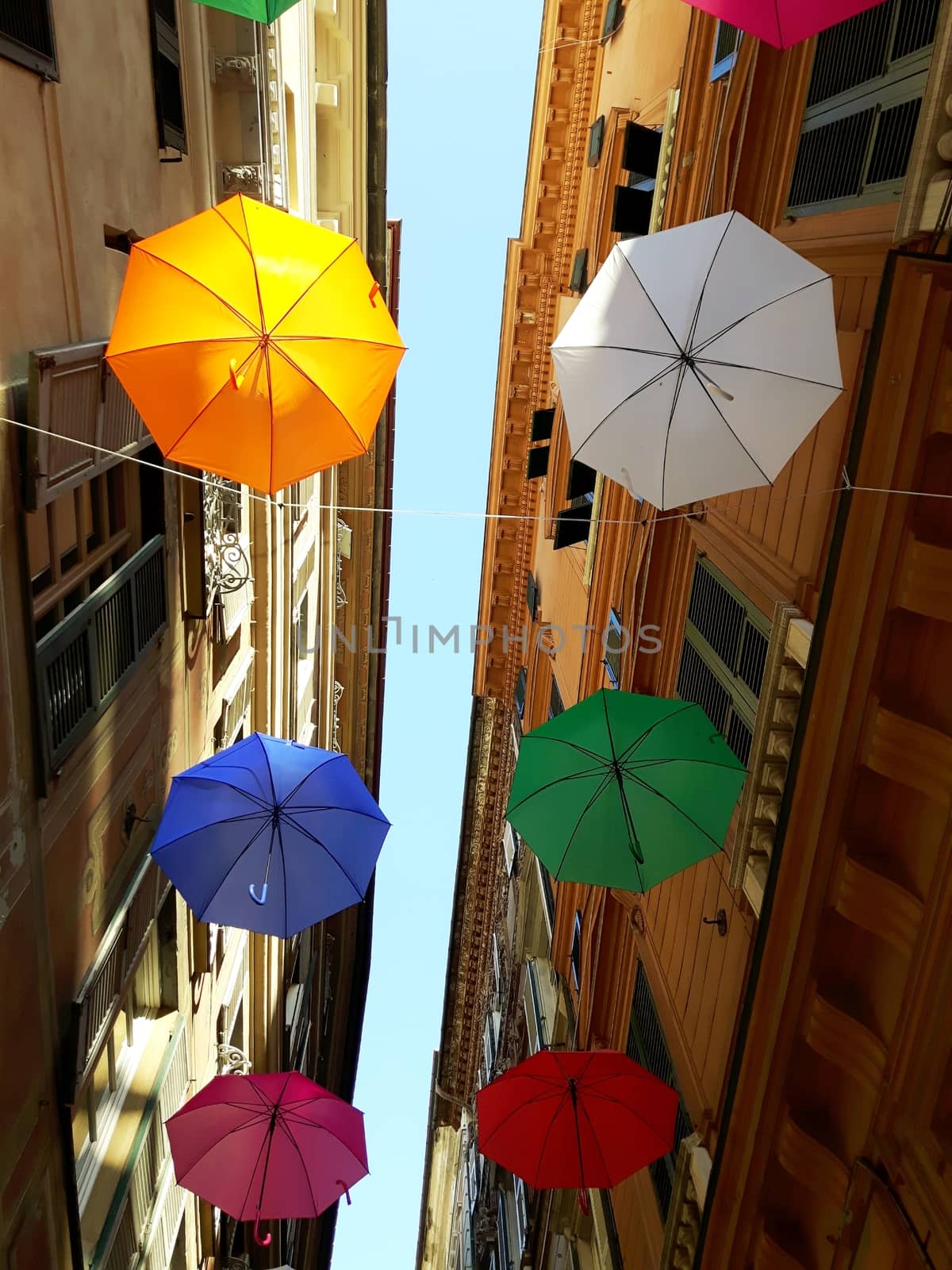 Genova, Italy - 06/01/2020: Bright abstract background of jumble of rainbow colored umbrellas over the city celebrating gay pride