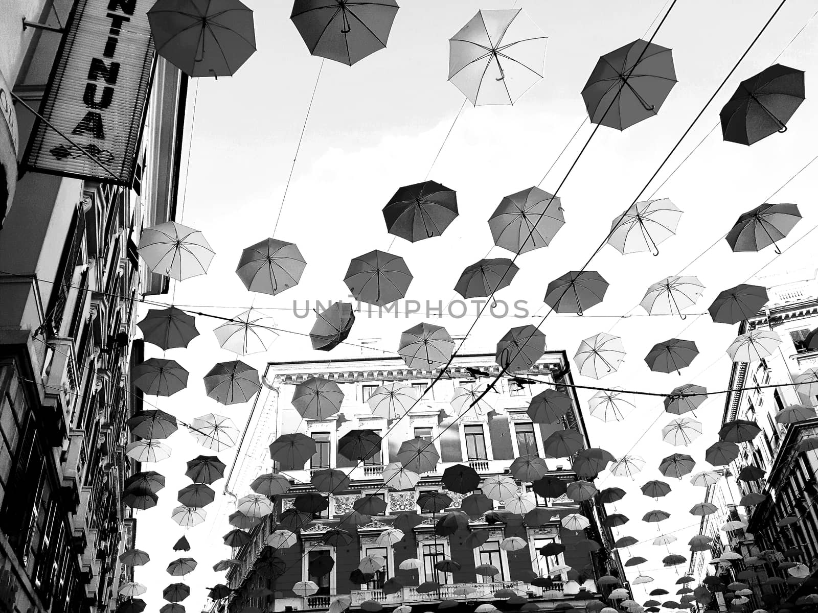 Genova, Italy - 06/01/2020: Bright abstract background of jumble of rainbow colored umbrellas over the city celebrating gay pride