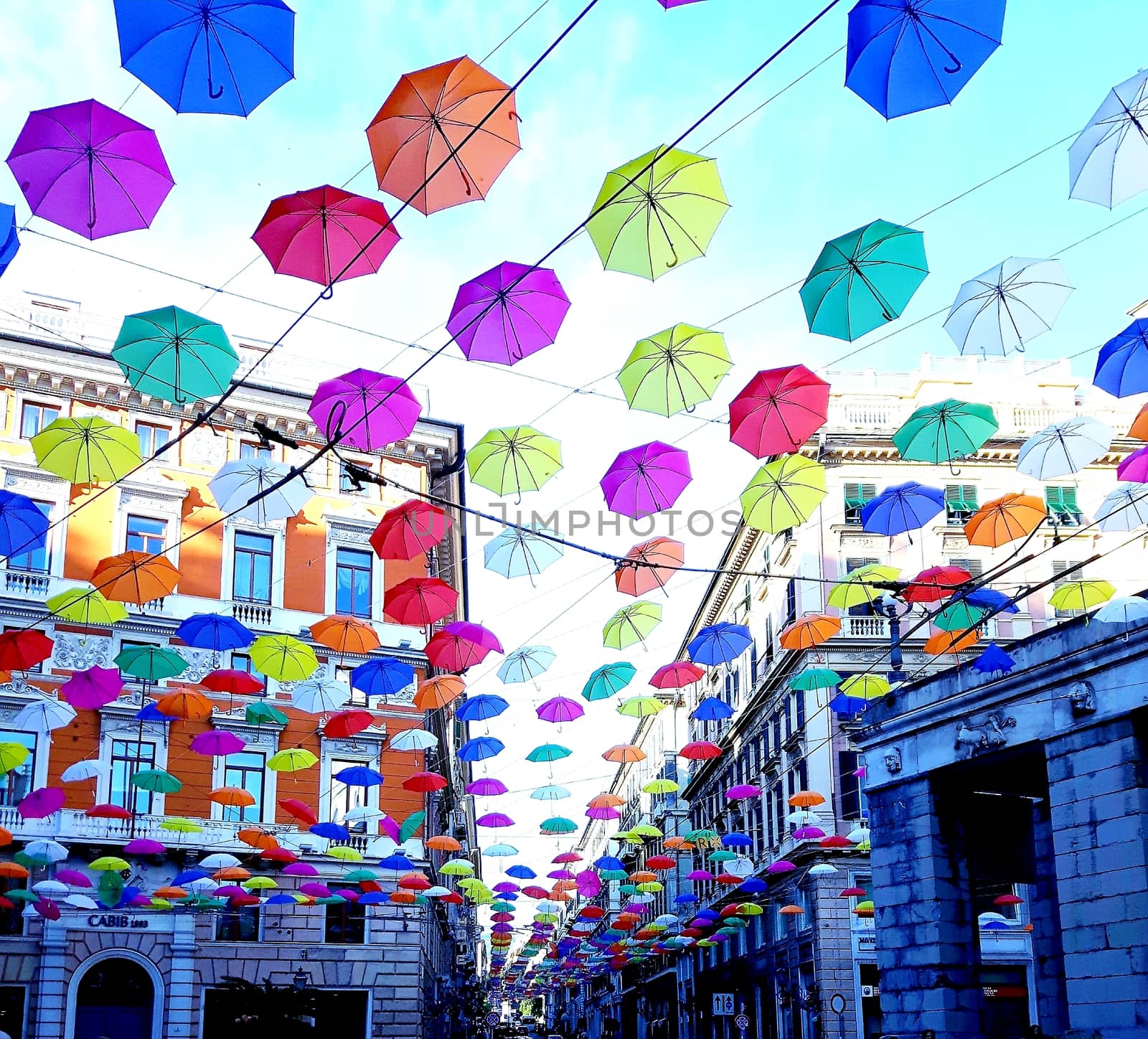 Genova, Italy - 06/01/2020: Bright abstract background of jumble of rainbow colored umbrellas over the city celebrating gay pride