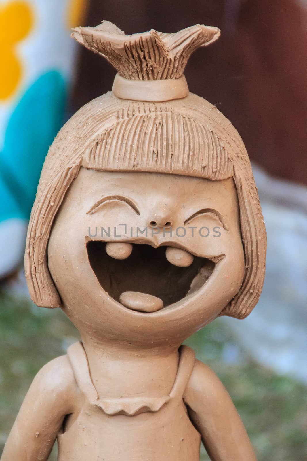 Happy Ceramic dolls for garden decoration. Cute ceramic clay pottery of girl show her up-swept bun and broken tooth that happy laughing until her eyes closed. Happy dolls for garden decoration.