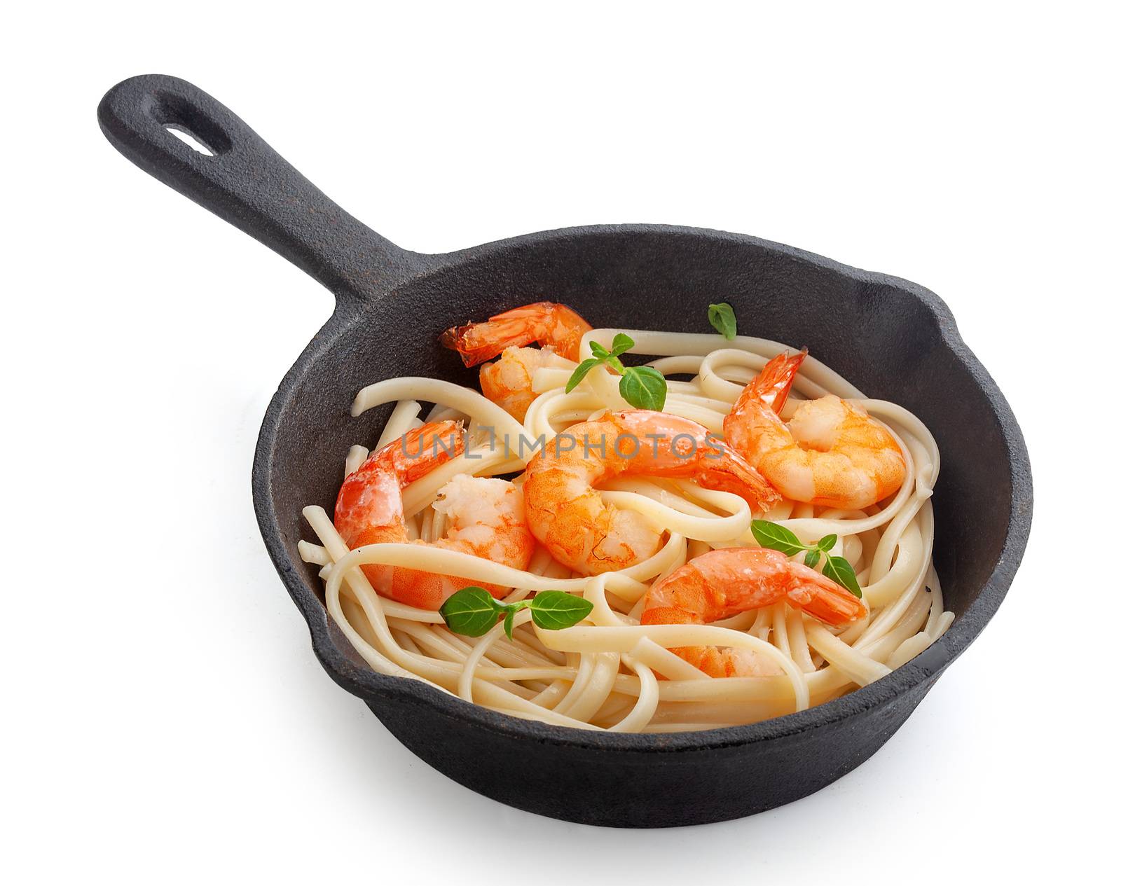 Fried shrimps with prepared pasta in the iron pan