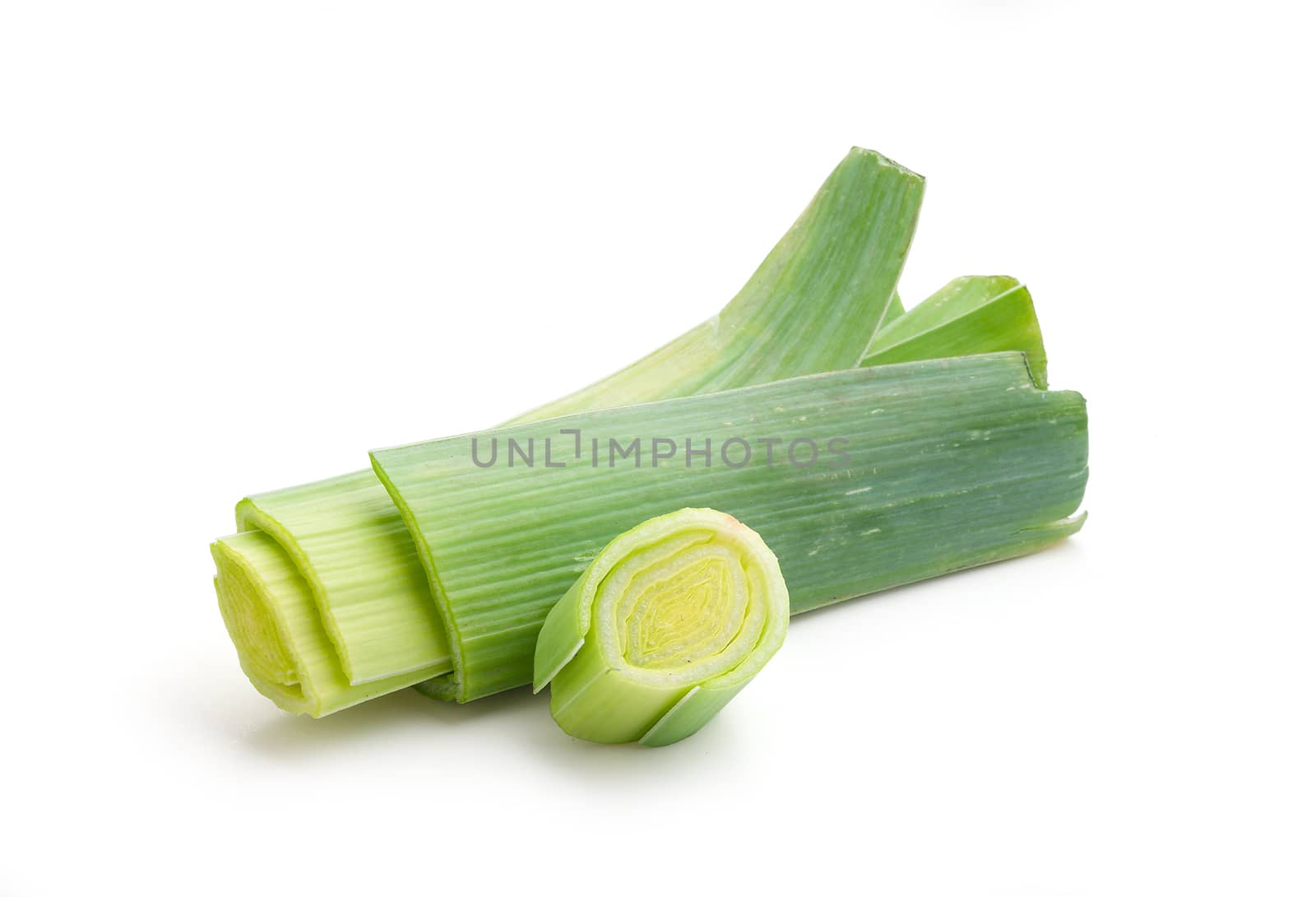 Isolated pieces of fresh green leek on the white background