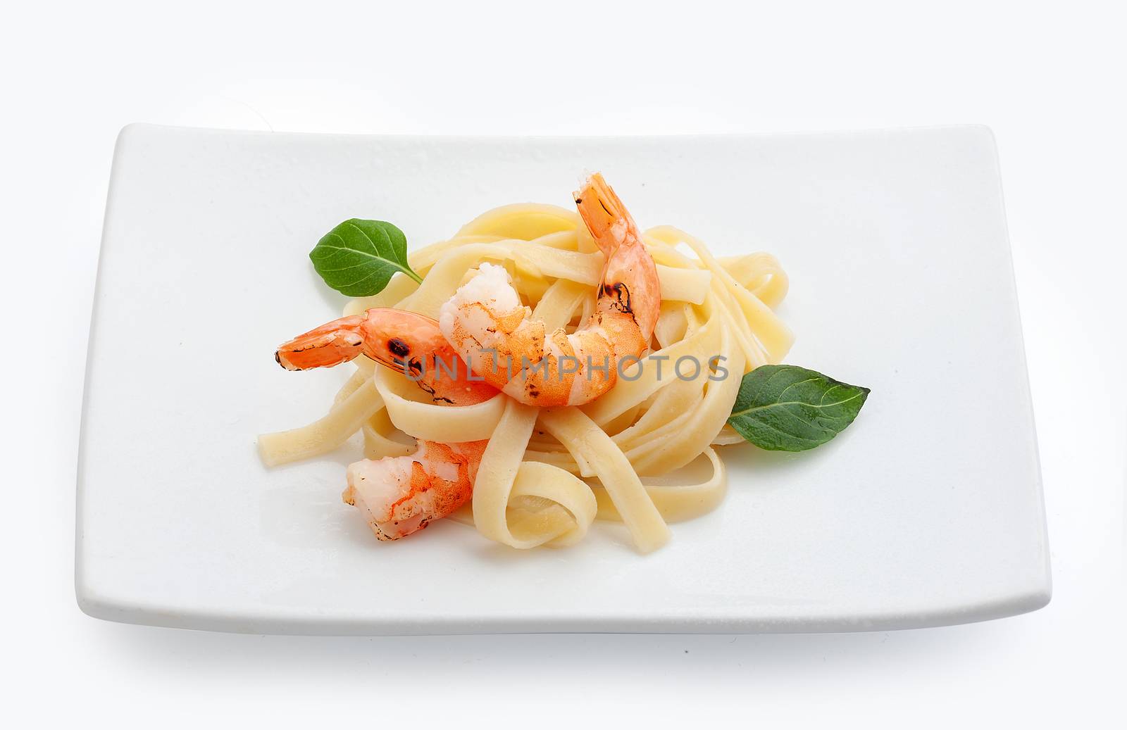 Roasted shrimps with pasta on the plate