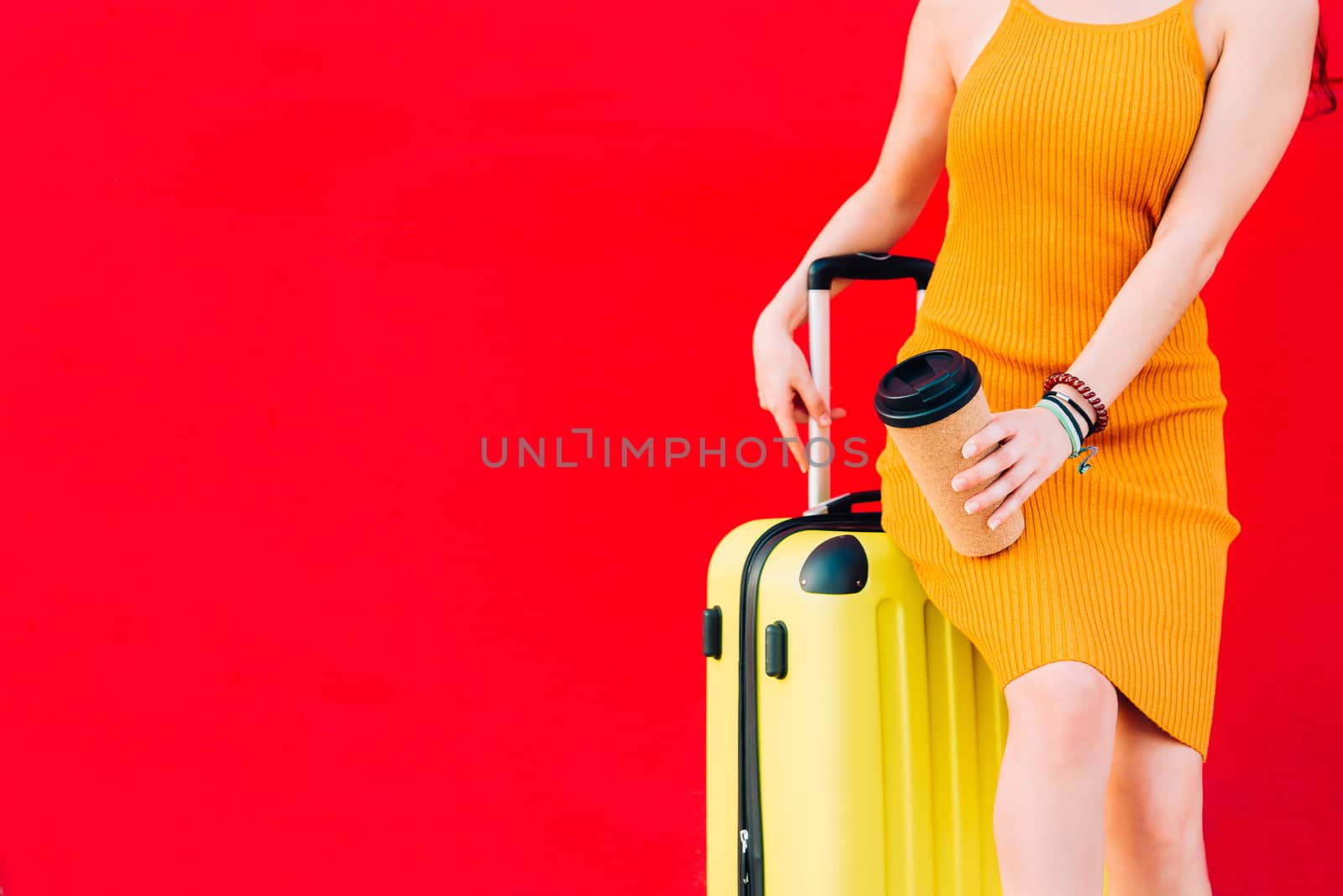 woman sitting on a suitcase and drinking coffee