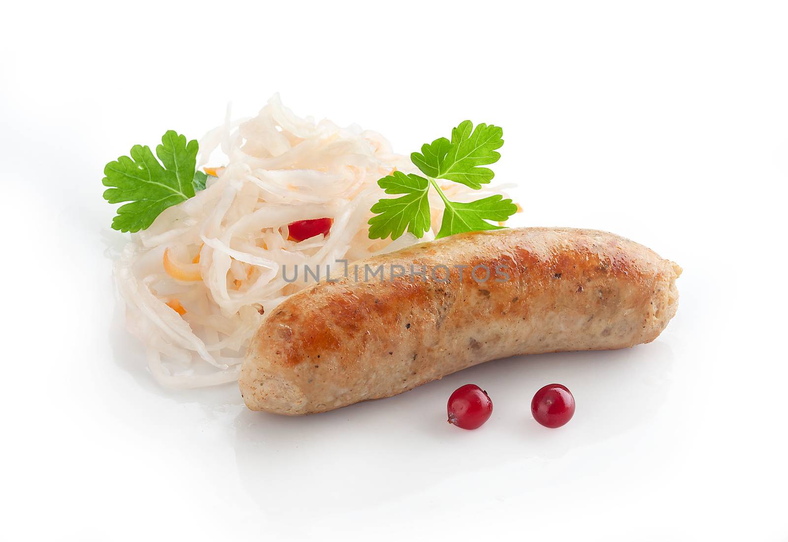 Isolated fried sausage with some sauerkraut, cranberry and fresh green parsley