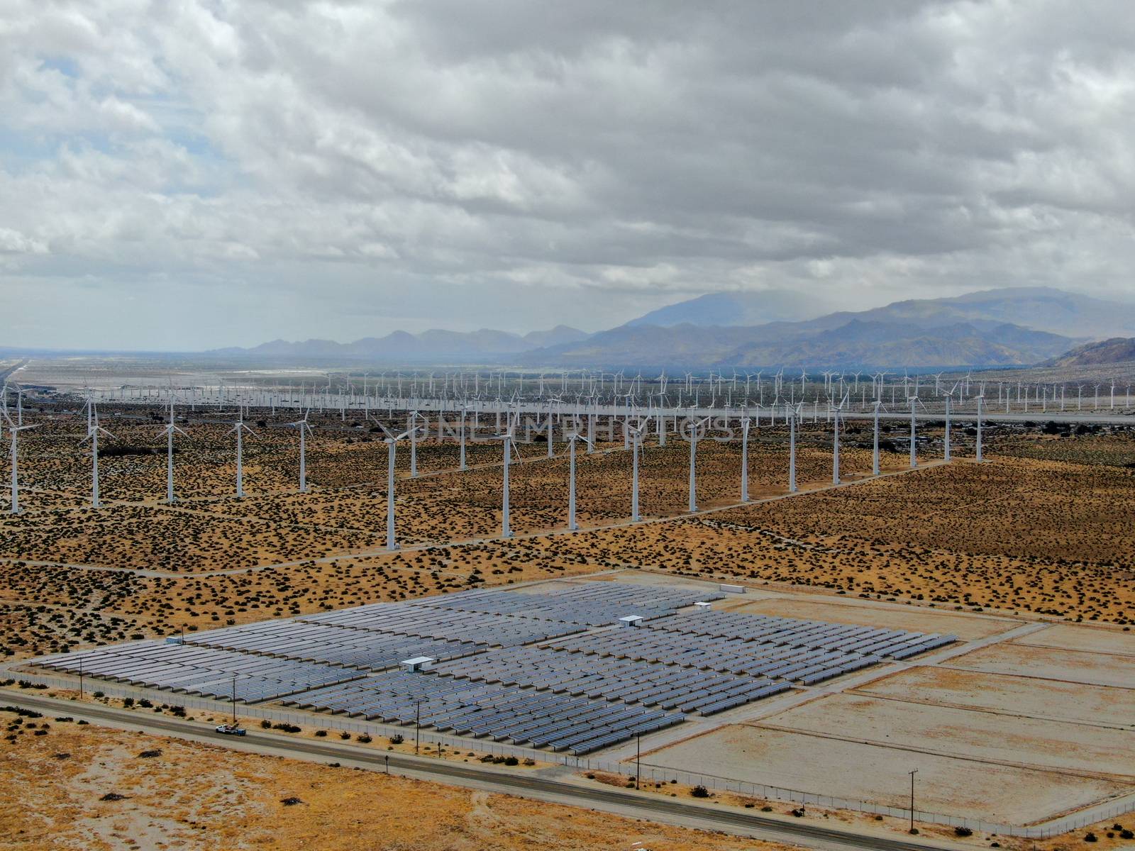 Aerial view of Genuine Energy Farm in the Hot Arid Desert of Palm Springs, California. Solar Panels farm to Harness the Power of Nature to generate free green energy.