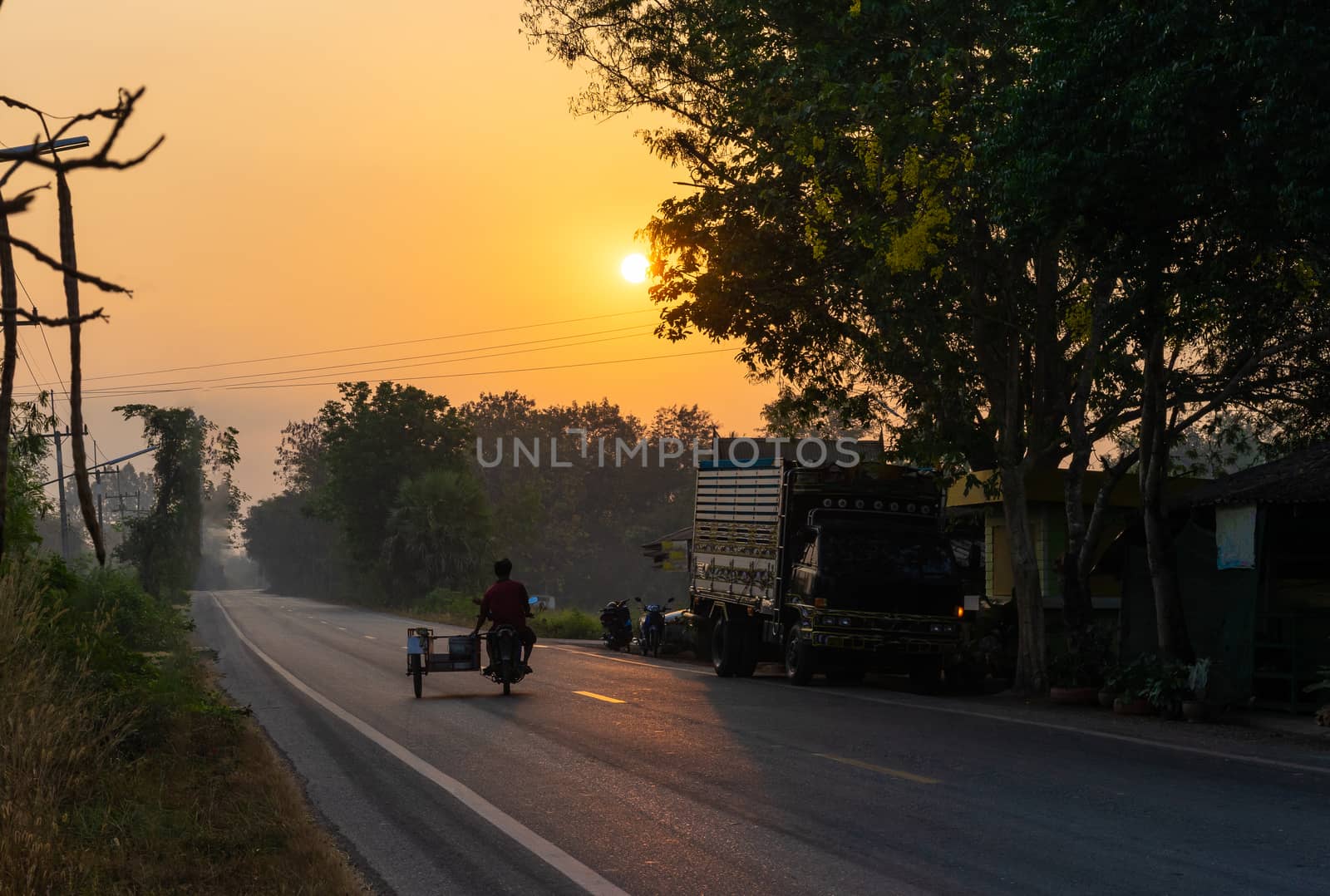motorcycle on asphalt road in countryside and sunshine morning