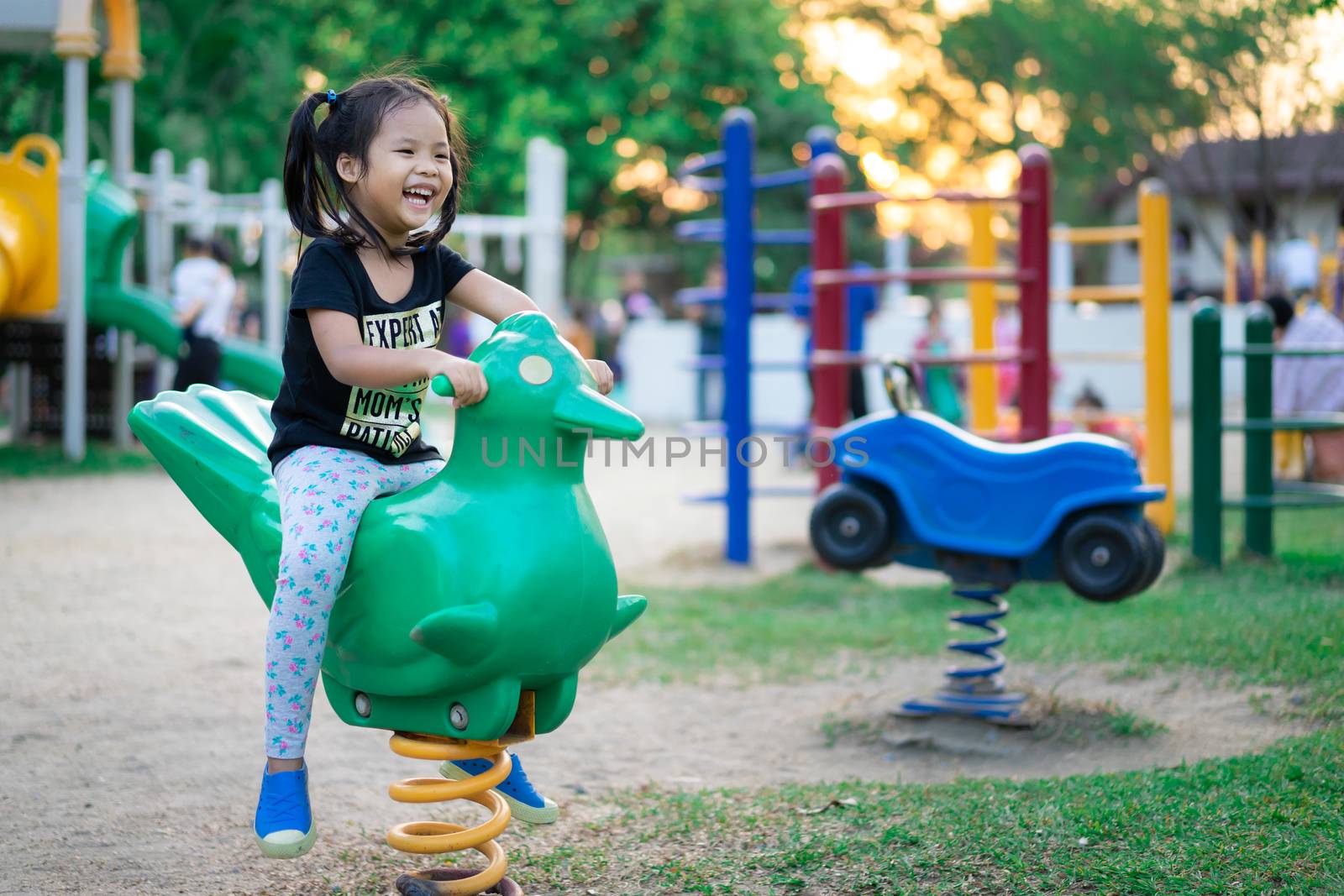 Asian little girl enjoys playing in a children playground