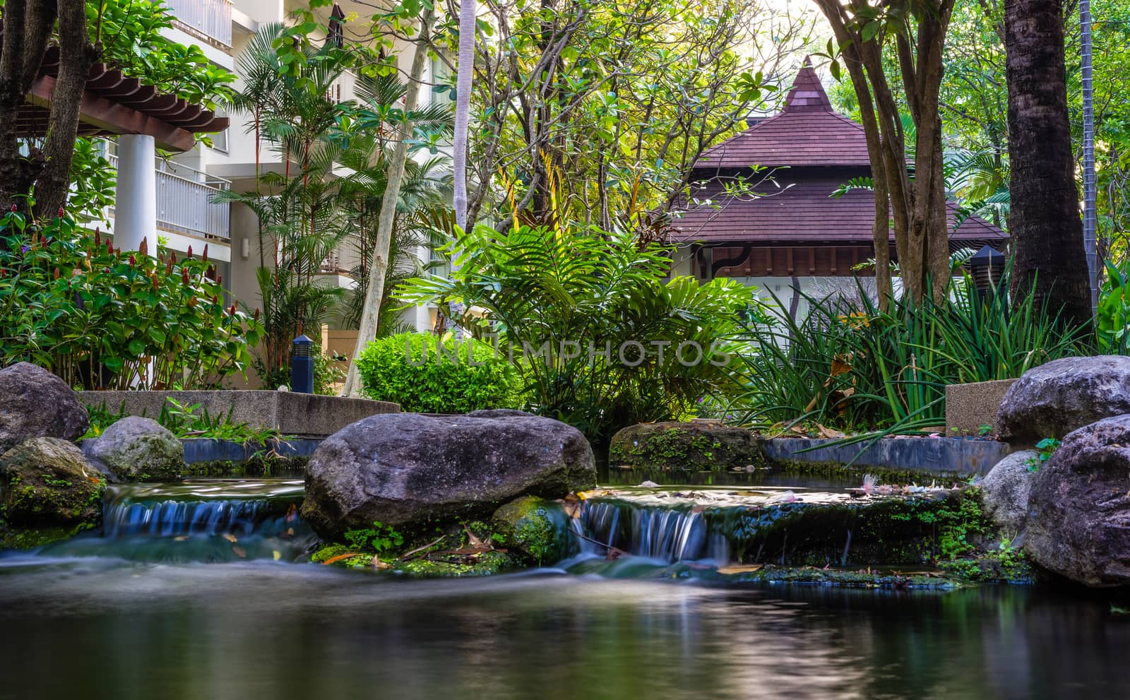 Corner of waterfall and rocks in the garden. Natural style decoration.