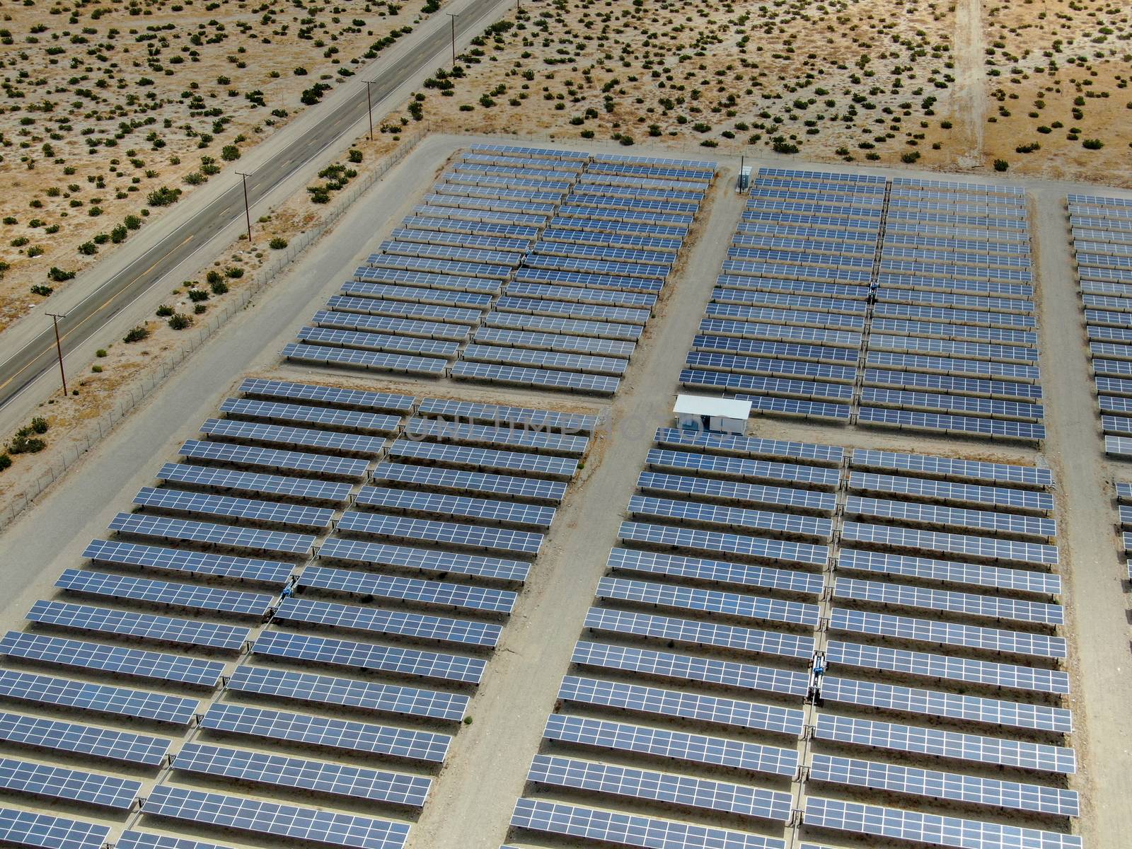 Aerial view of Genuine Energy Farm in the Hot Arid Desert of Palm Springs, California. Solar Panels farm to Harness the Power of Nature to generate free green energy.